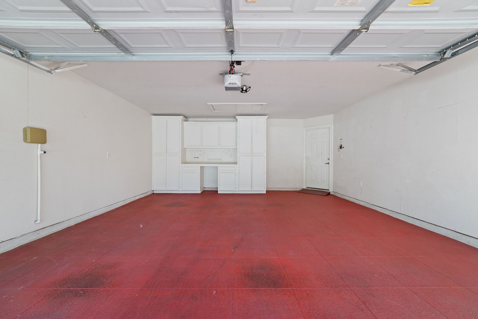 Garage with custom flooring and custom cabinets