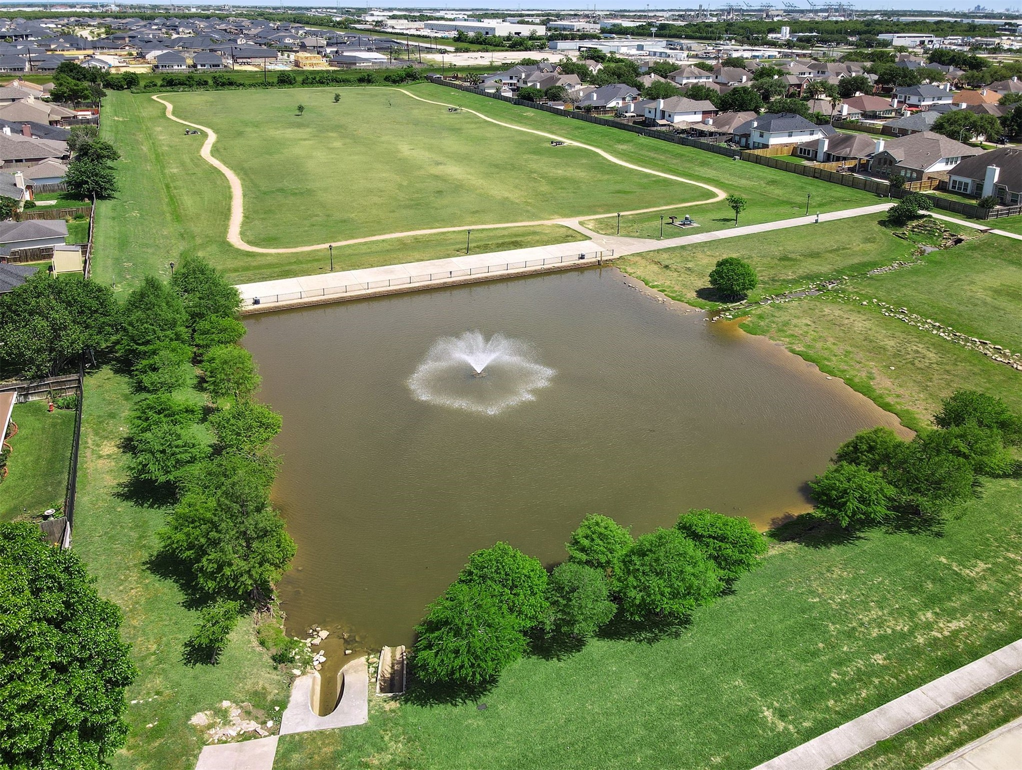 Beautiful Woodfalls Park Features a Scenic Pond with Fountain, Walking Trails, and Expansive Green Space for Enjoying the Outdoors!