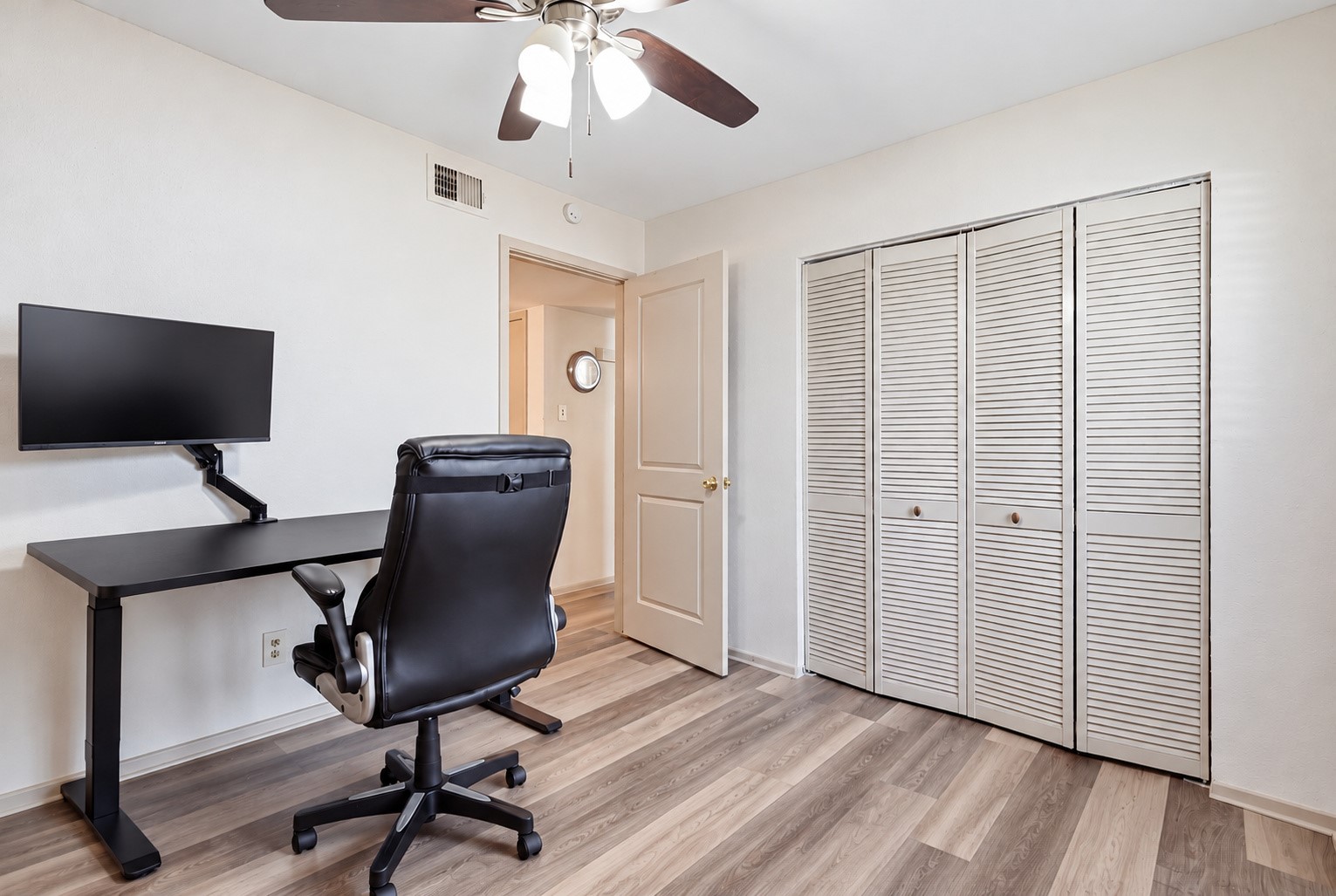 Versatile second bedroom offers space for guests, a home office or personal use.