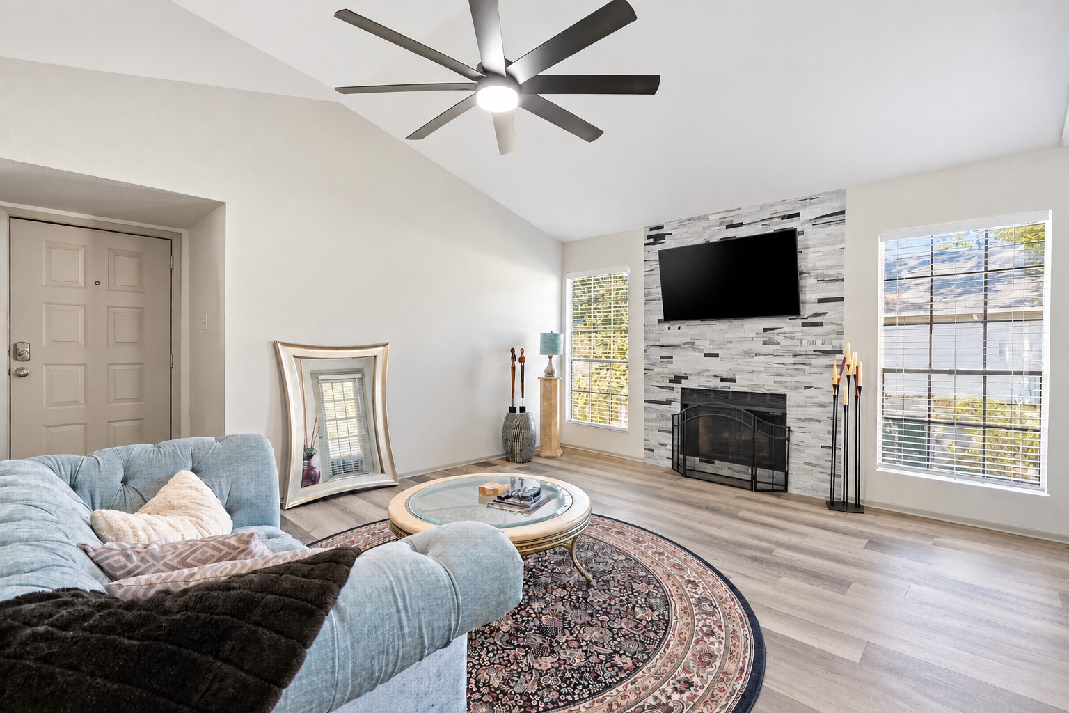 Welcome to a bright and inviting living area featuring a wood burning fireplace and space to entertain. Welcome to a bright and inviting living area featuring a wood burning fireplace and space to entertain.