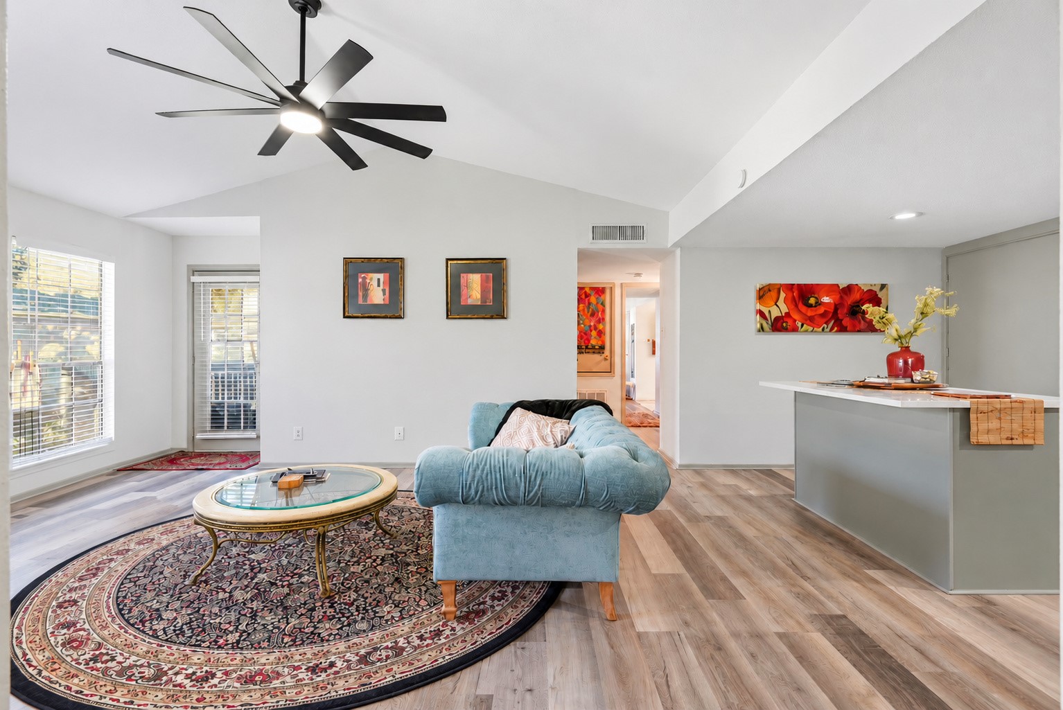 Another angle of the living area highlighting its comfortable layout  with access to a private balcony.