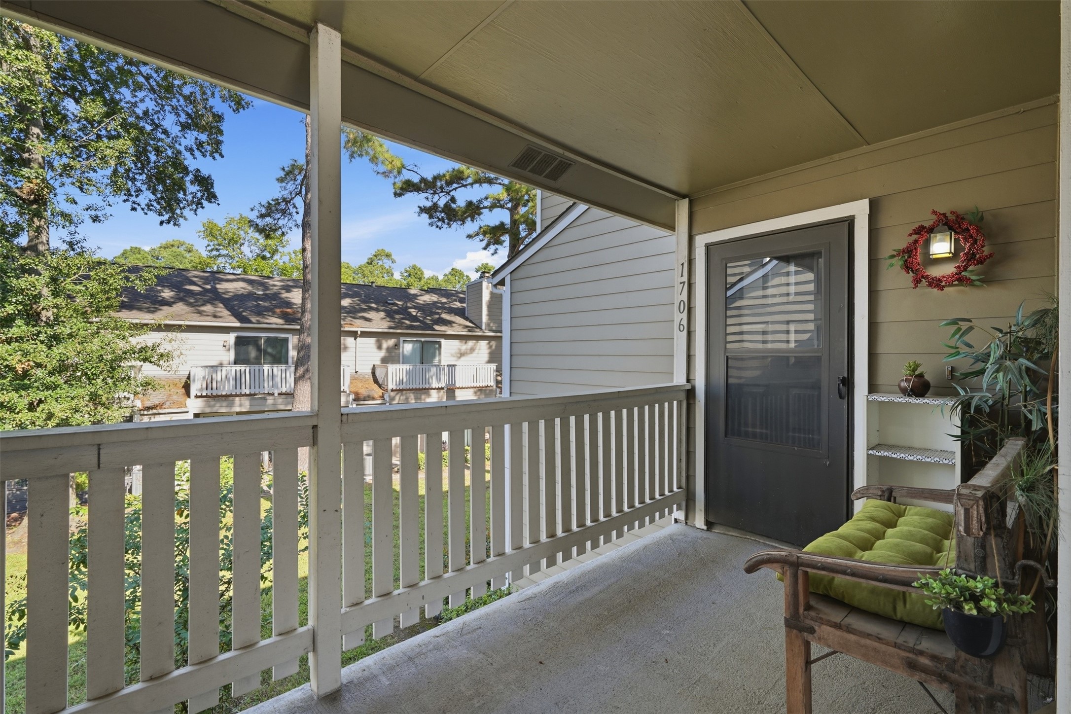 Welcoming covered entry leading to the condominium residence.