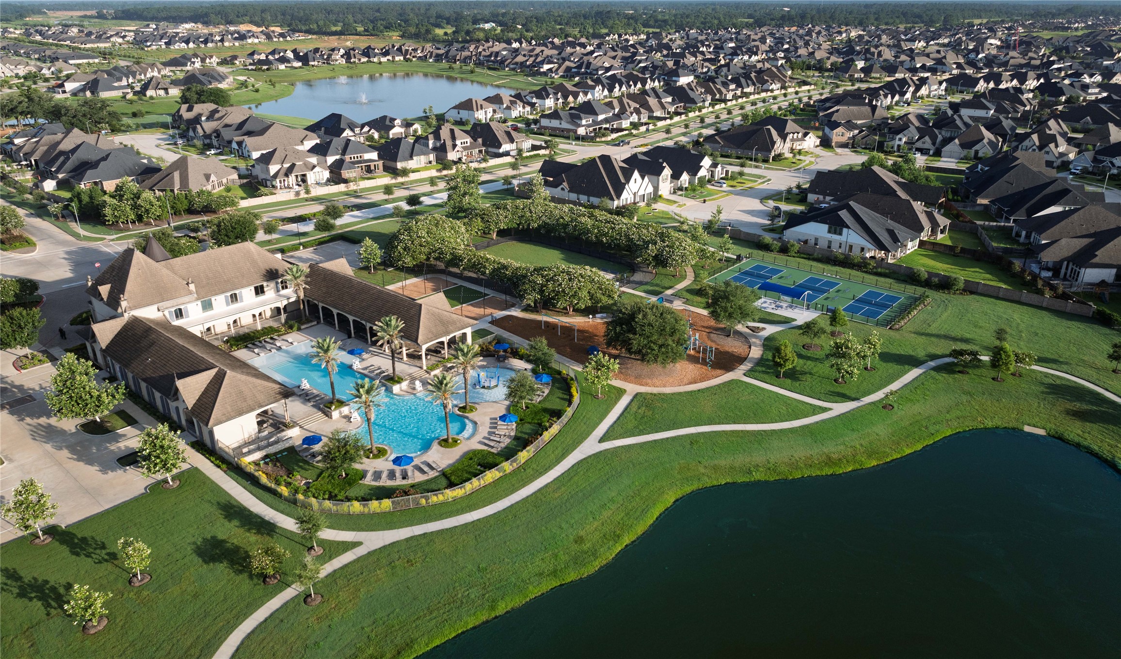 The community pool at Amira, often referred to as The Resort at Amira, is a centerpiece amenity designed to resemble a high-end vacation destination.