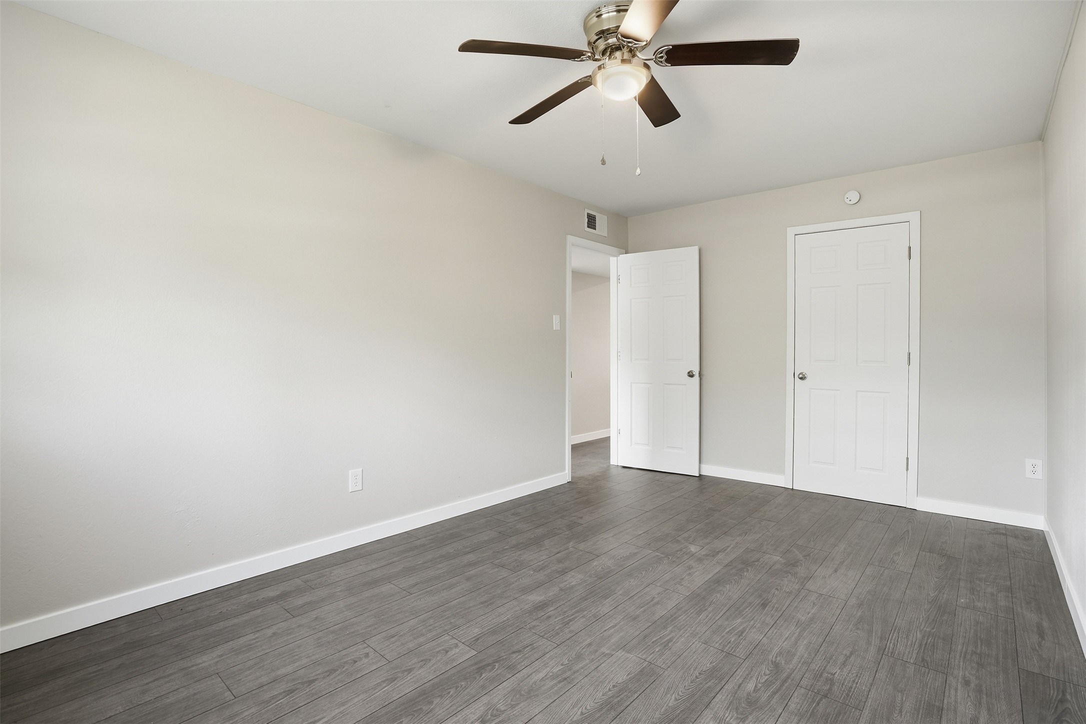 Spacious primary bedroom with ample natural light and a comfortable layout.