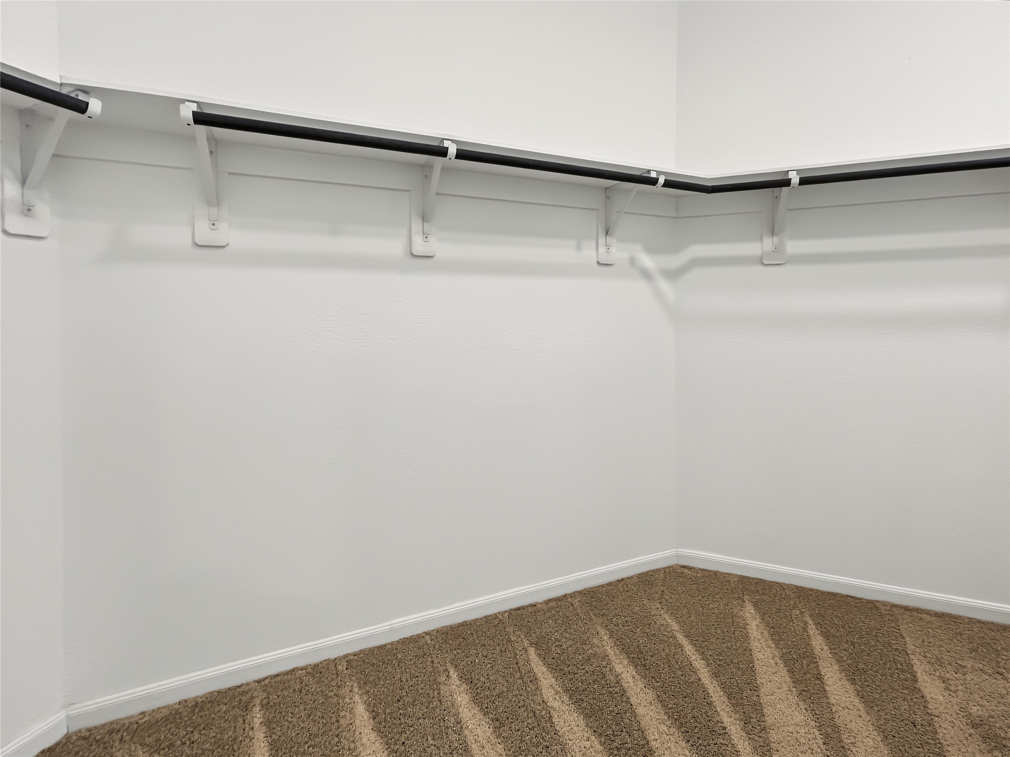 View of the ample walk-in closet inside the primary bathroom.