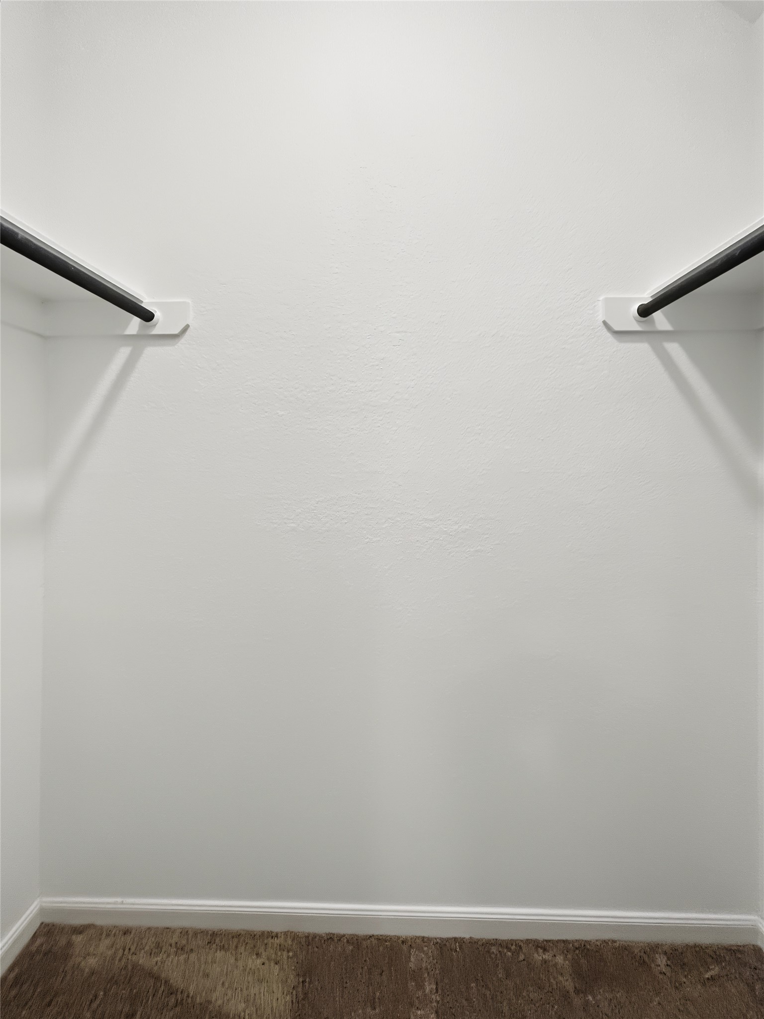 View of the walk-in closet inside of one of the secondary bedrooms.