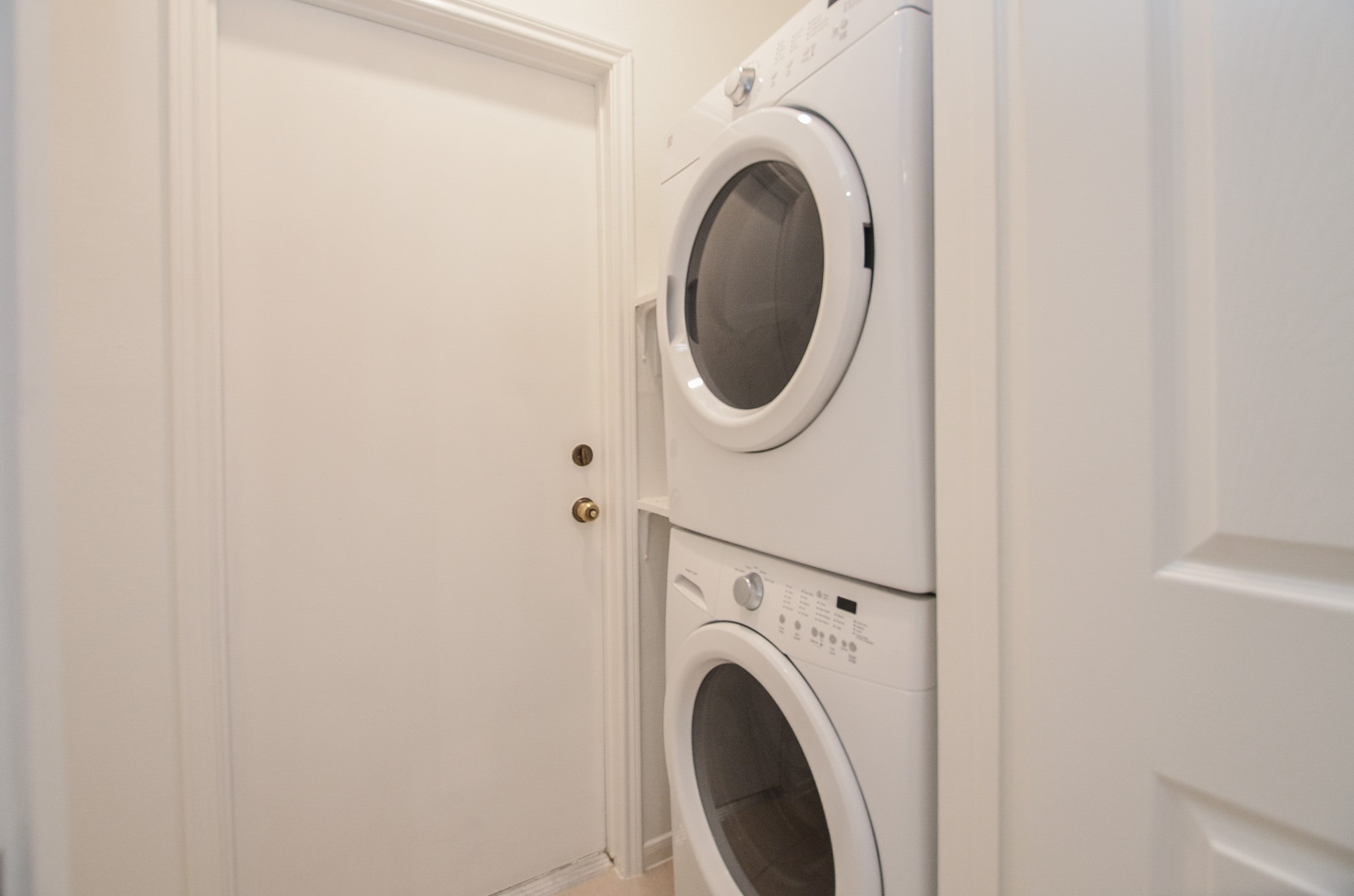 This is to show that a stackable washer and dryer fits perfect in this laundry space.