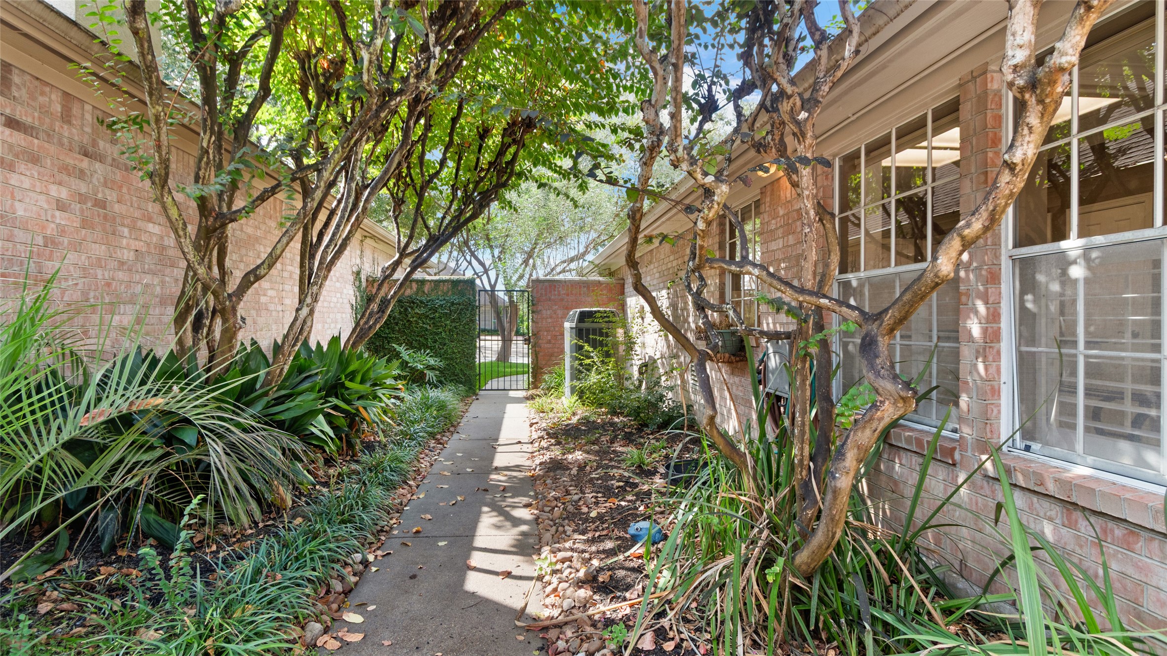 Beautifully landscaped backyard with a charming garden entryway.