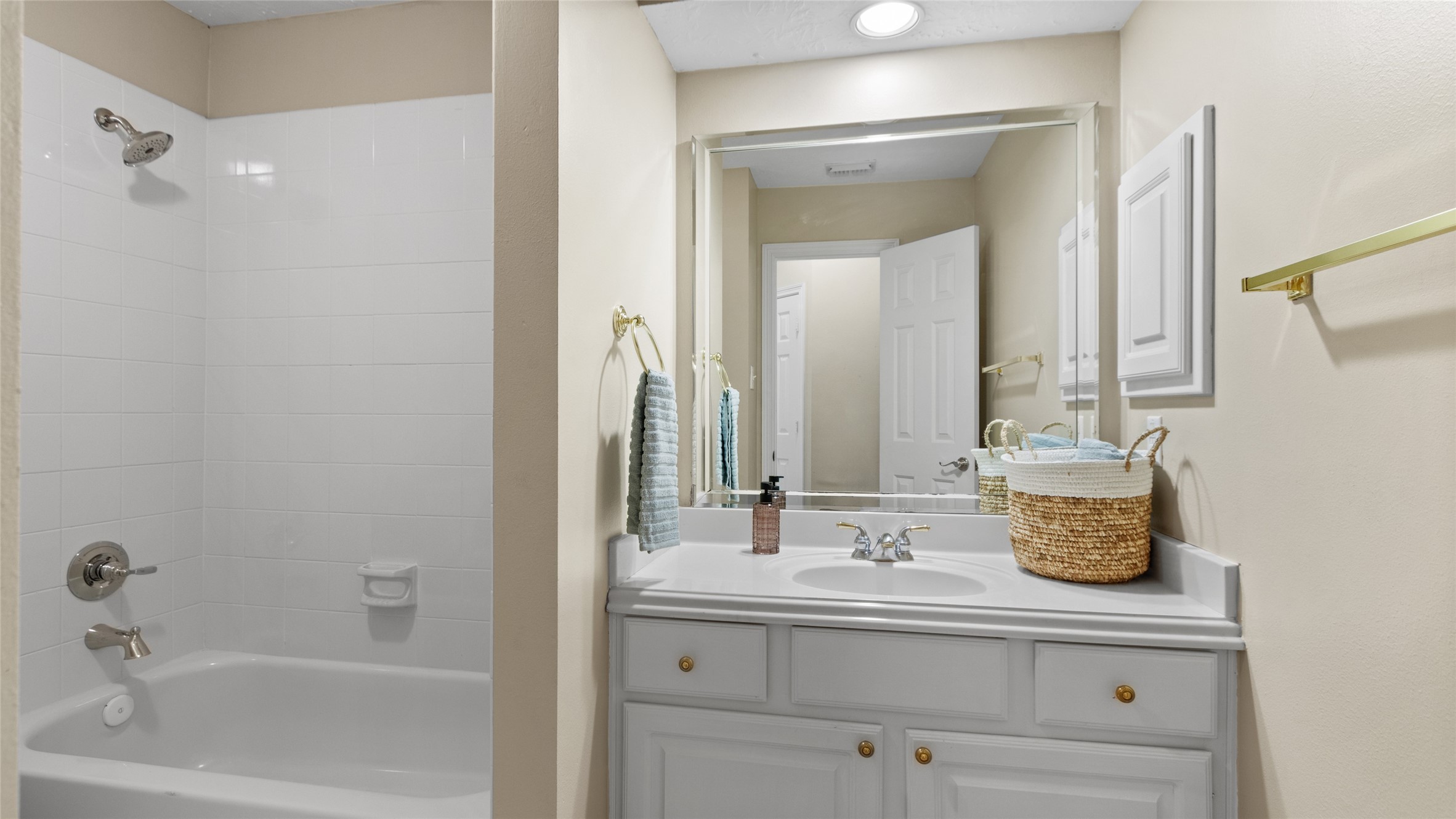 Secondary bathroom offers a tub and shower combination.
