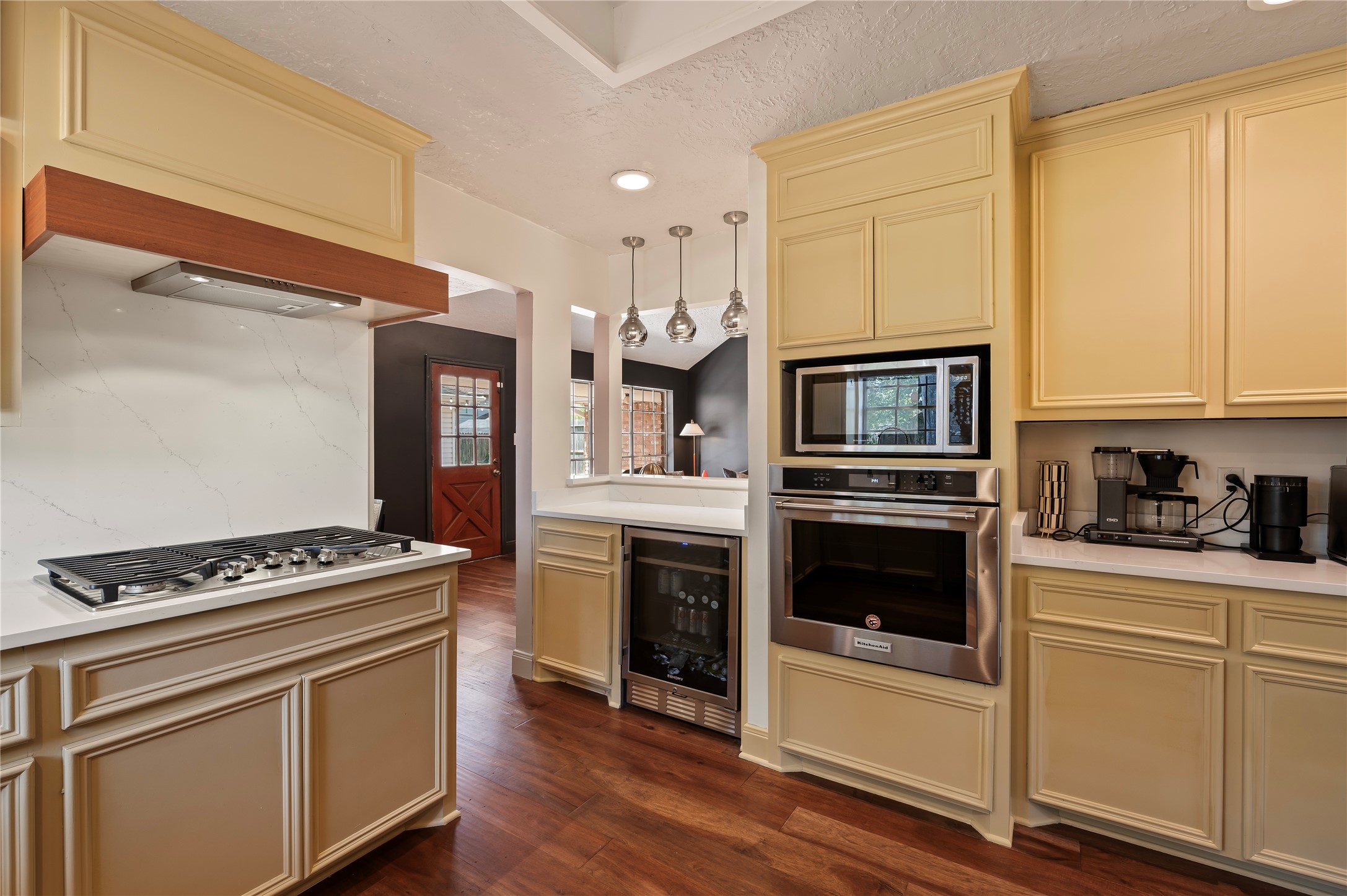 Built in stainless steel oven and microwave near the bar area with built in wine fridge.