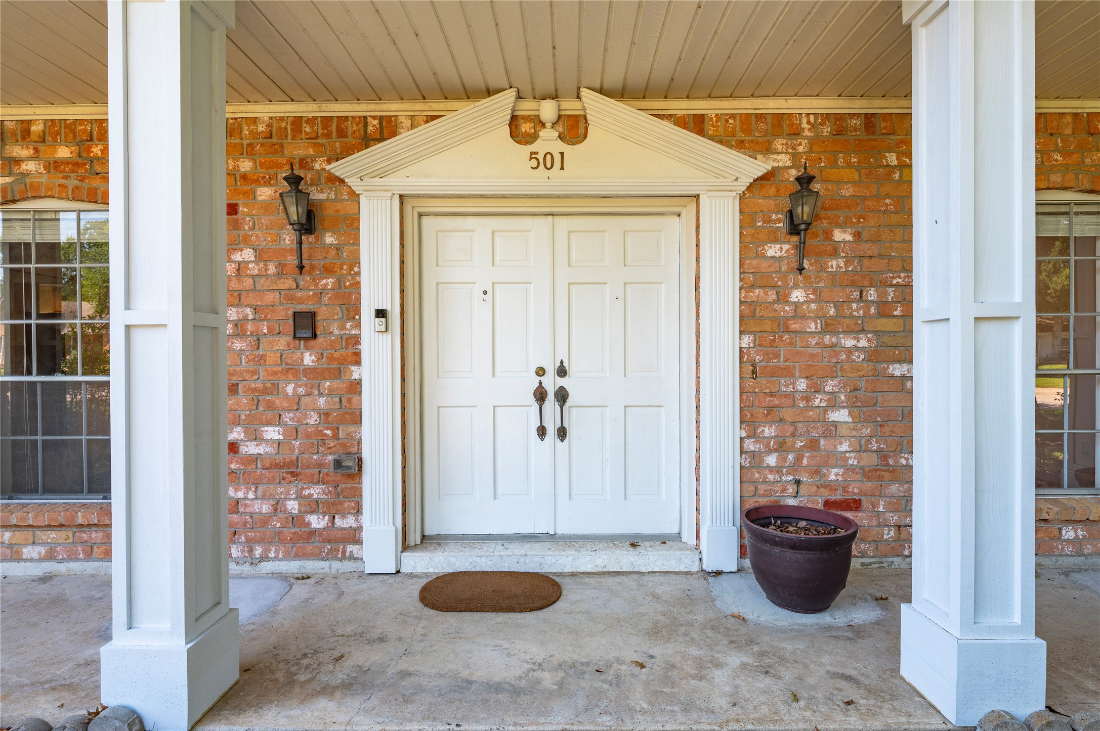 Double wood doors accent the front entryway.