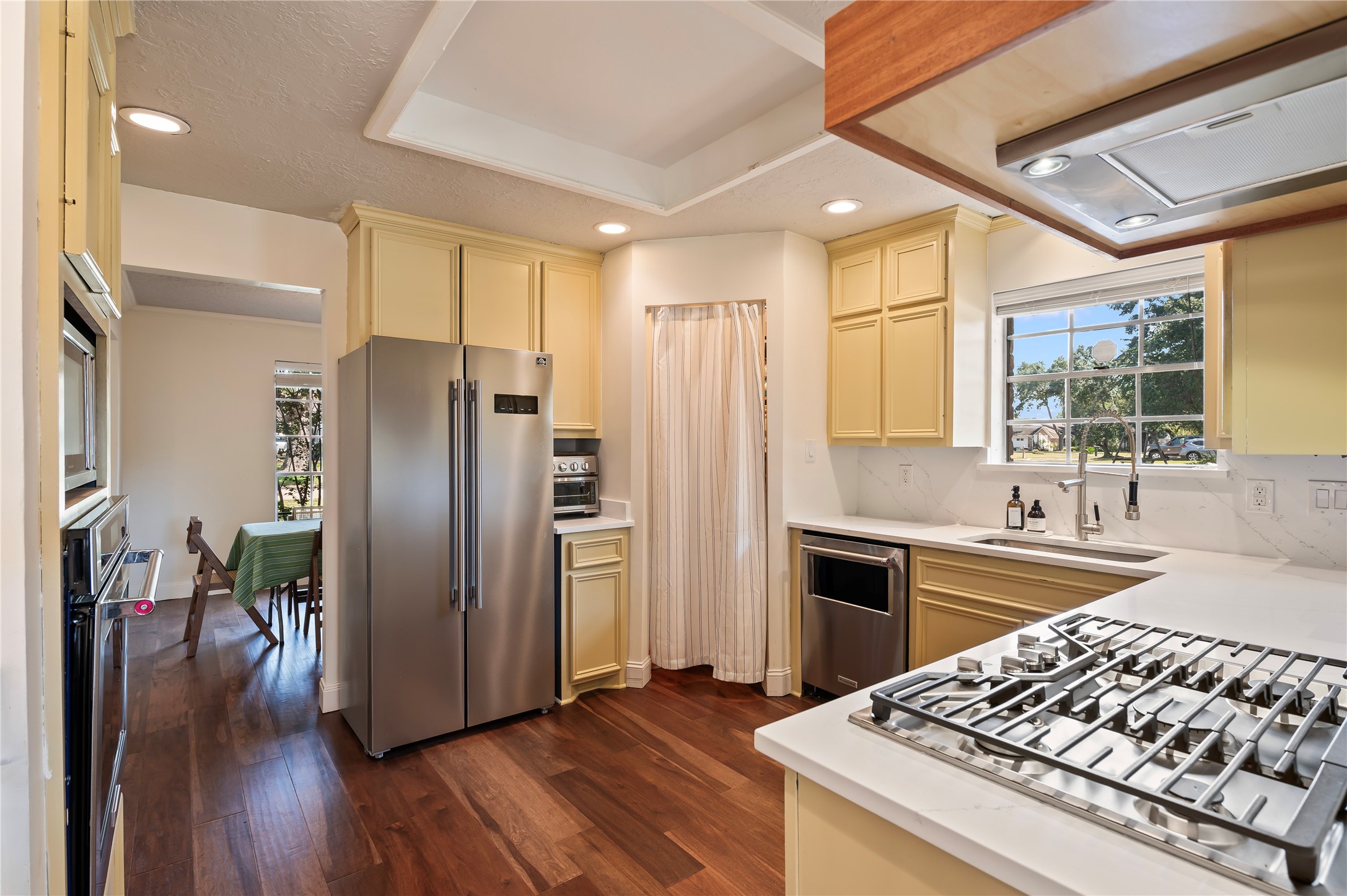 Beautiful kitchen area with tons of counter top space and wood cabinet storage. Stainless appliances throughout.