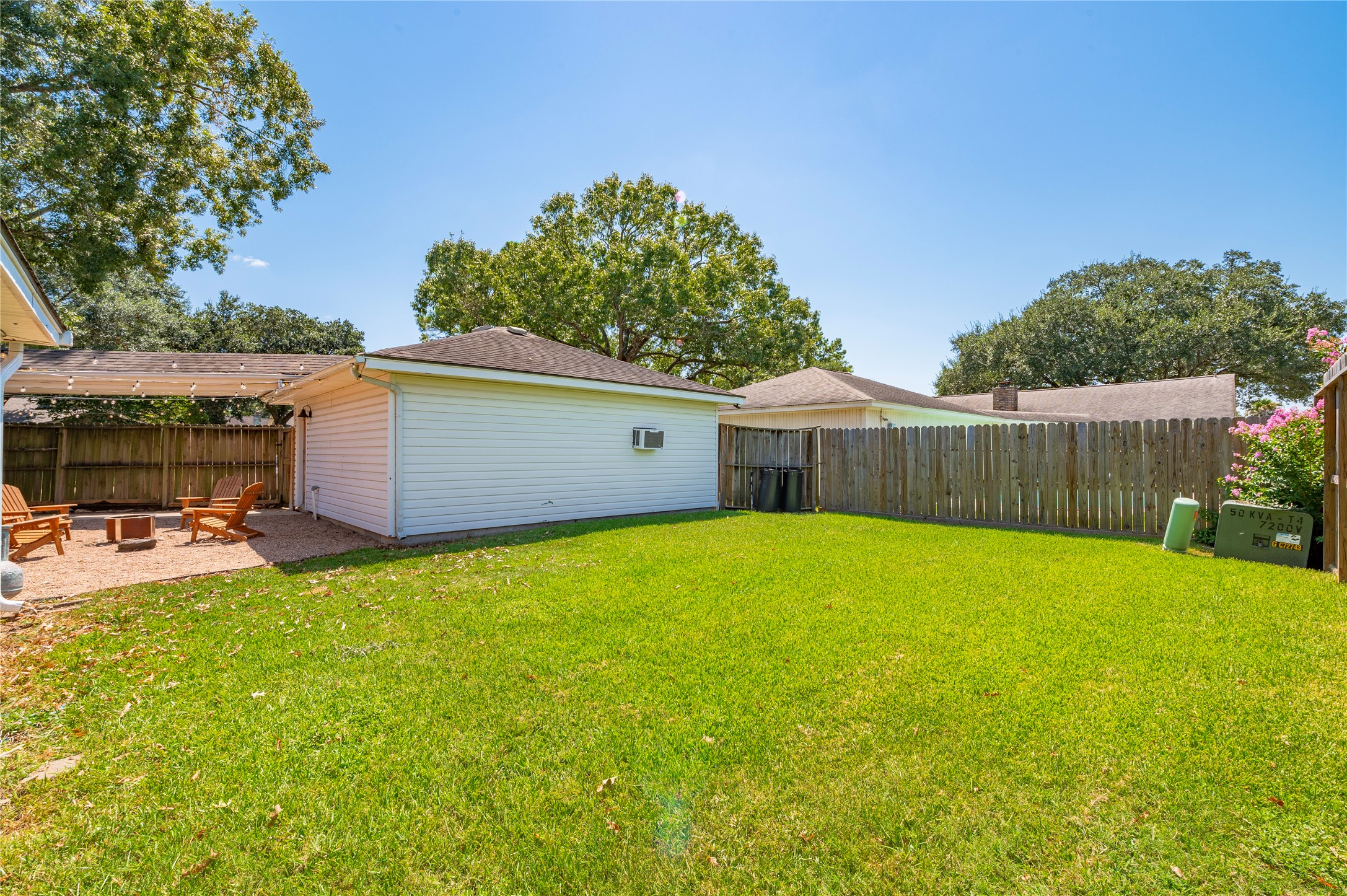 Additional large green backyard space with privacy fencing on all sides.