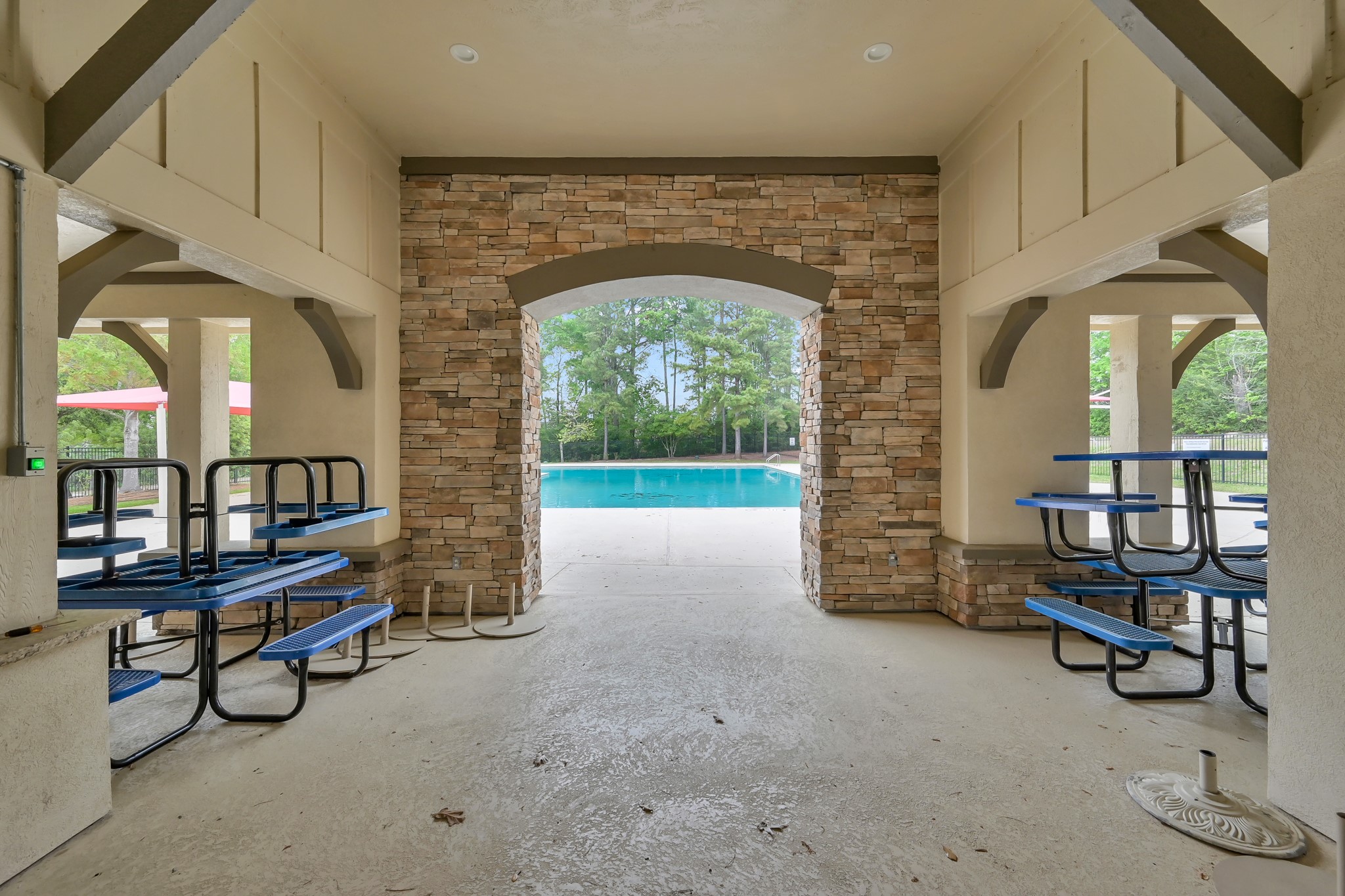 Graystone Hills community poolside pavilion featuring covered seating, picnic tables and beautiful stone accents, perfect for relaxing in the shade after a swim!