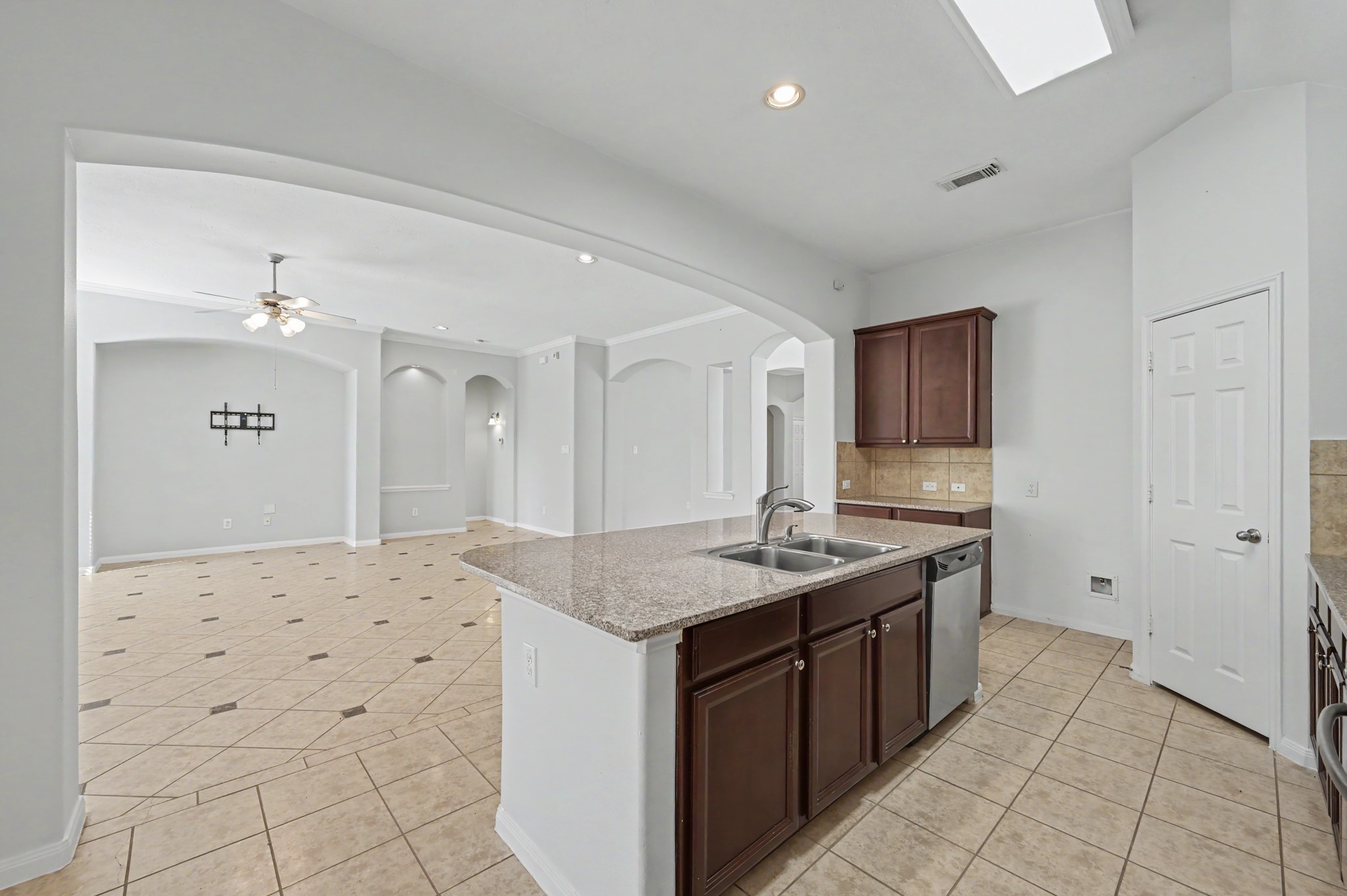 Open-concept island kitchen seamless flow into the spacious family room.