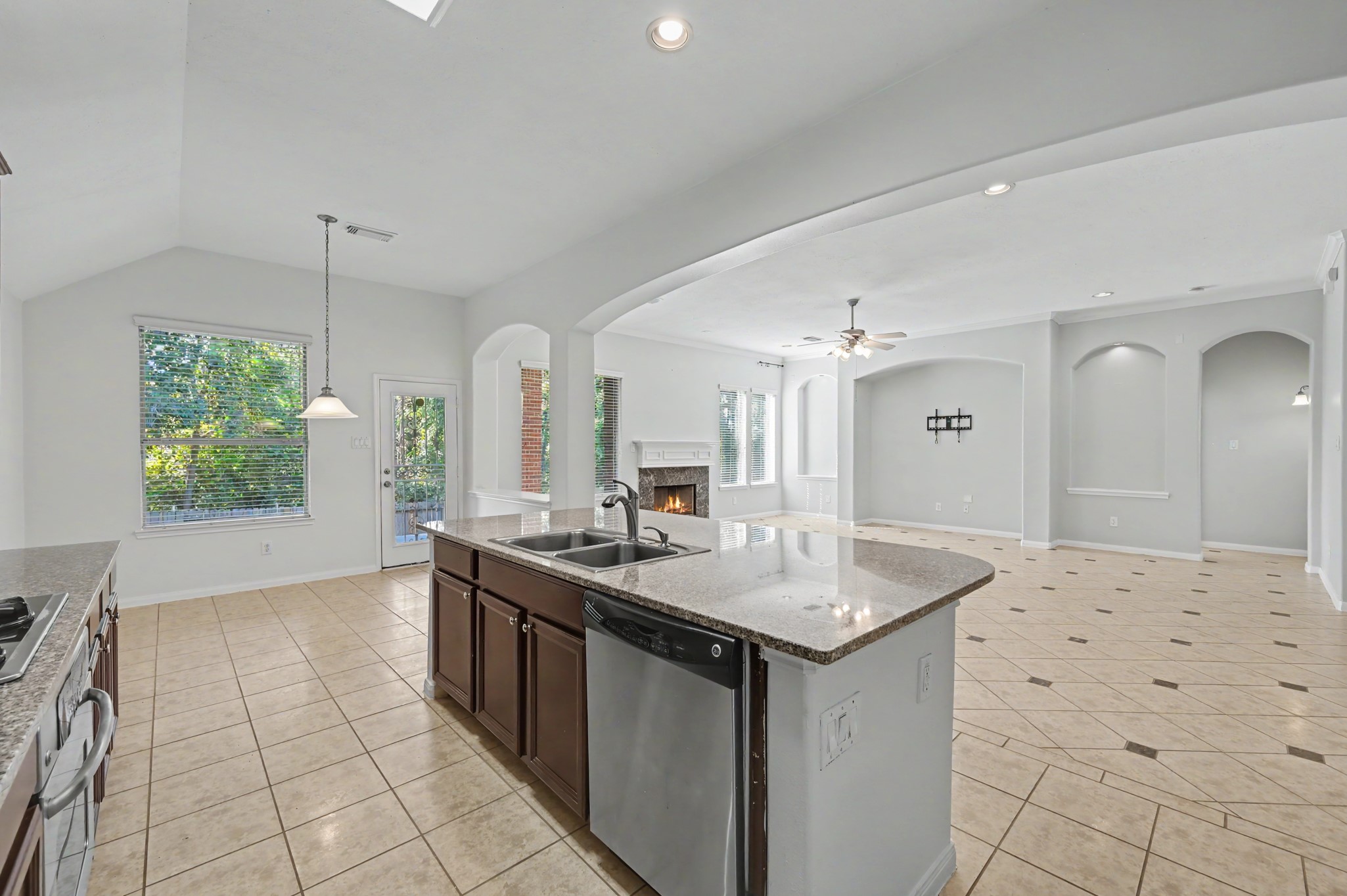 Open-concept island kitchen seamless flow into the breakfast room.
