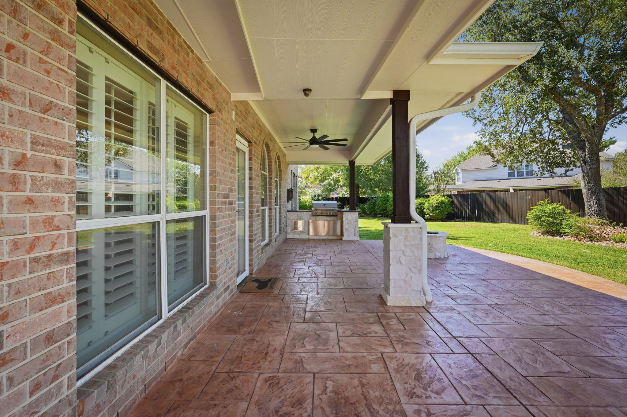 Covered patio with outdoor kitchen, perfect for entertaining.