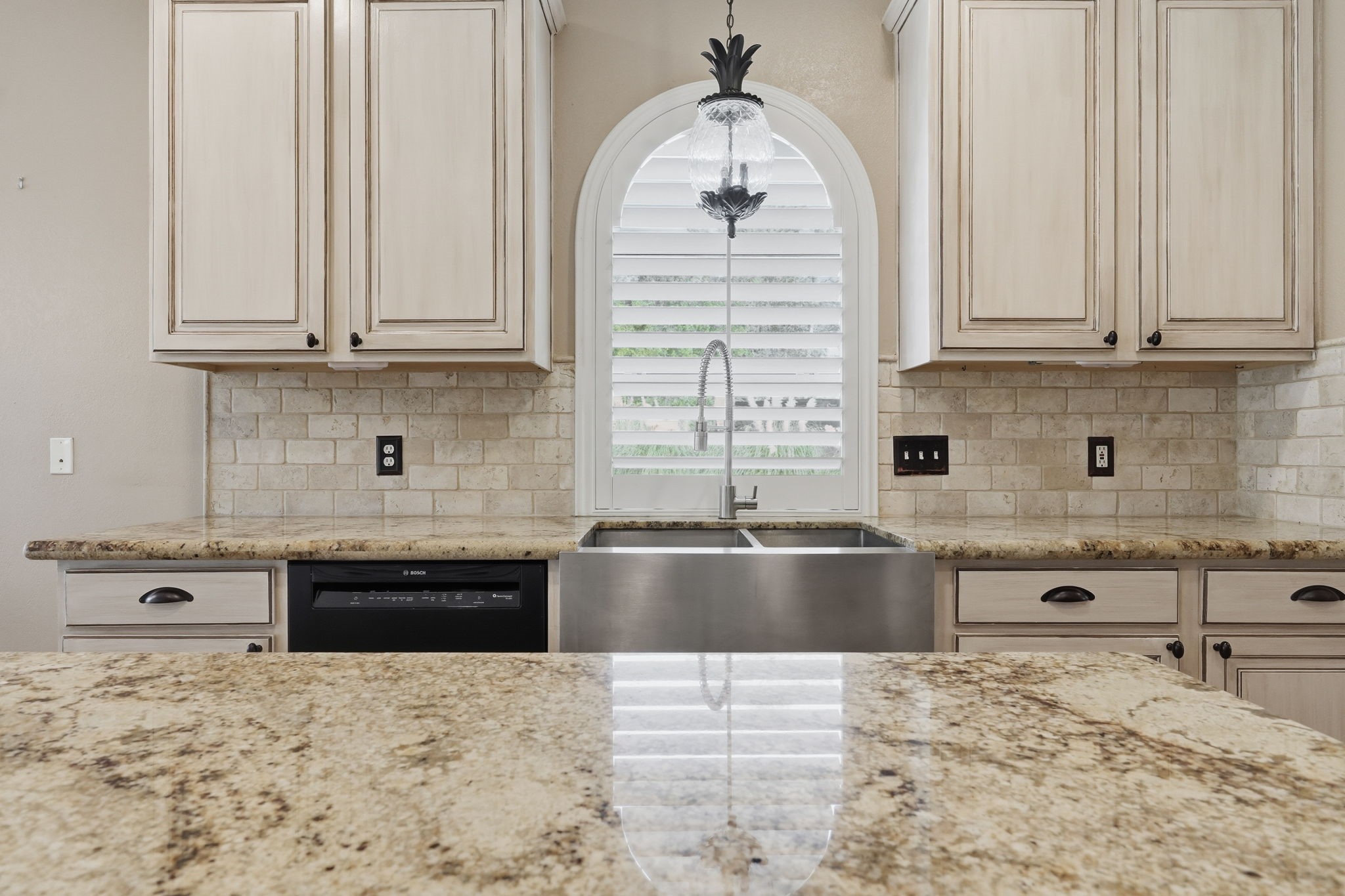 Spacious counters, a large island, and farmhouse sink.