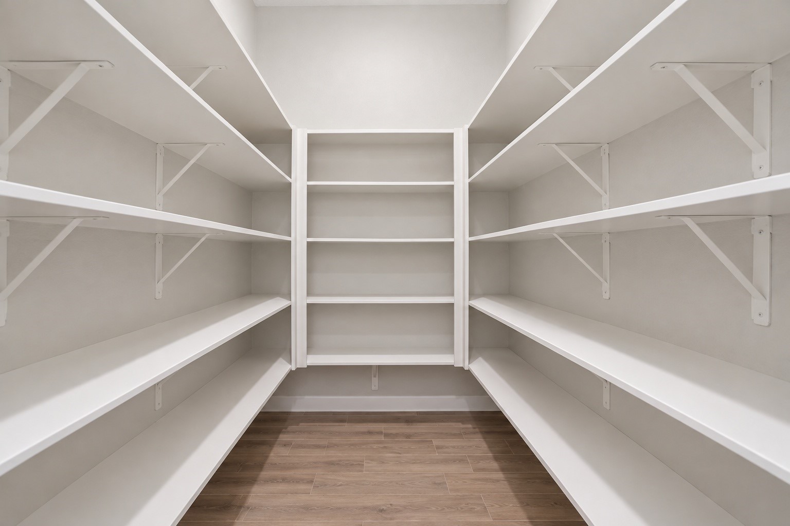 Large, spacious pantry with plenty of shelving for storage.
