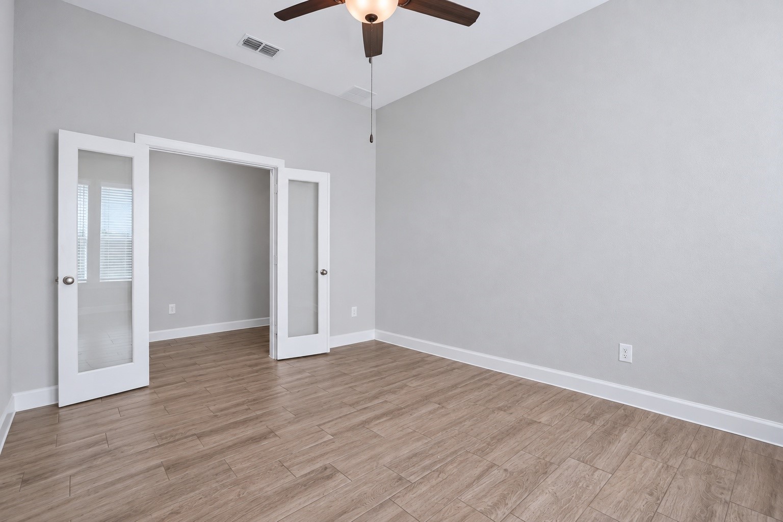 Private home office with French doors, perfect for work or study.