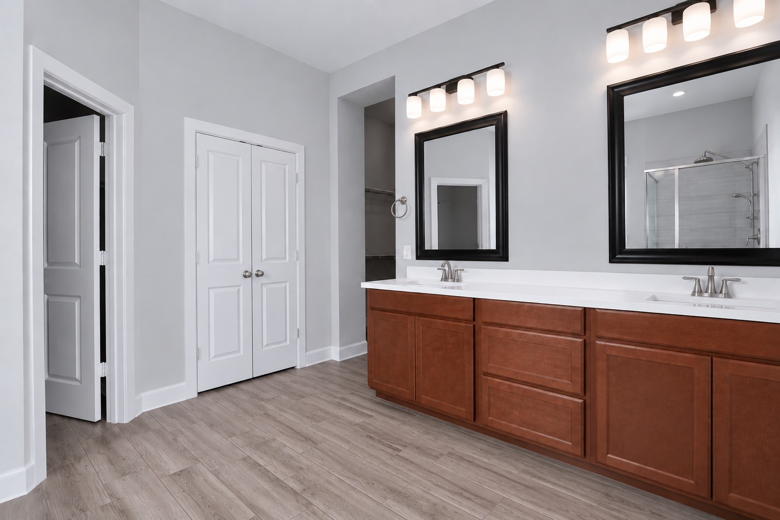 Spacious primary bathroom with dual sinks, a standalone shower, and a separate bathtub.