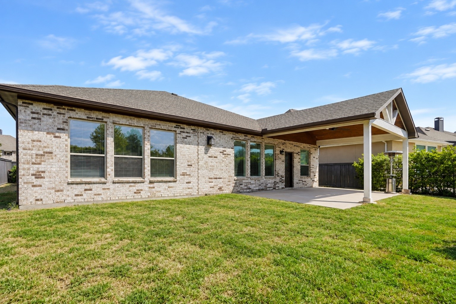 Spacious covered patio with ceiling fan and no back neighbors for added privacy.