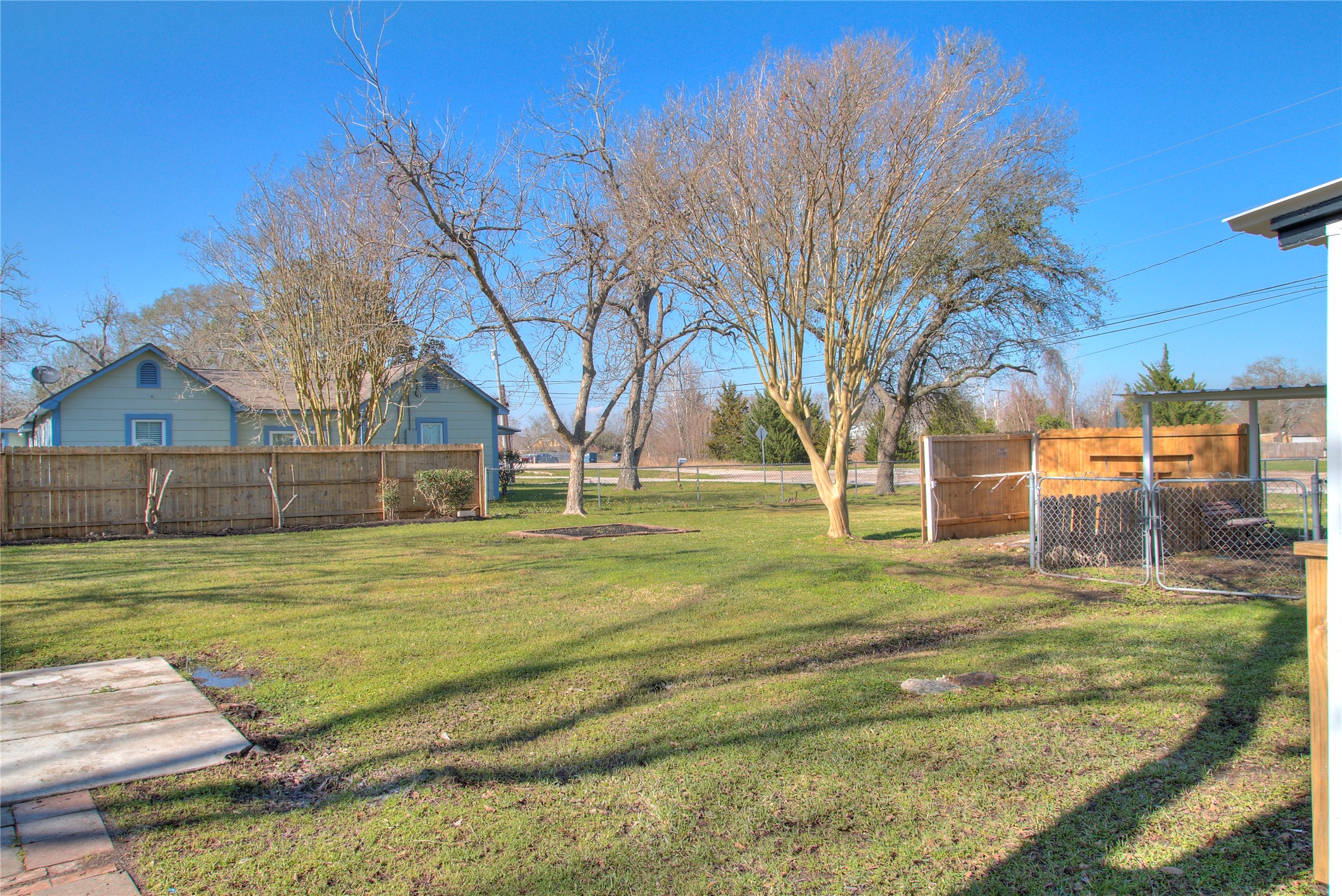 Spacious extra lot perfect for RV storage or building a private guest house with a wood fence.