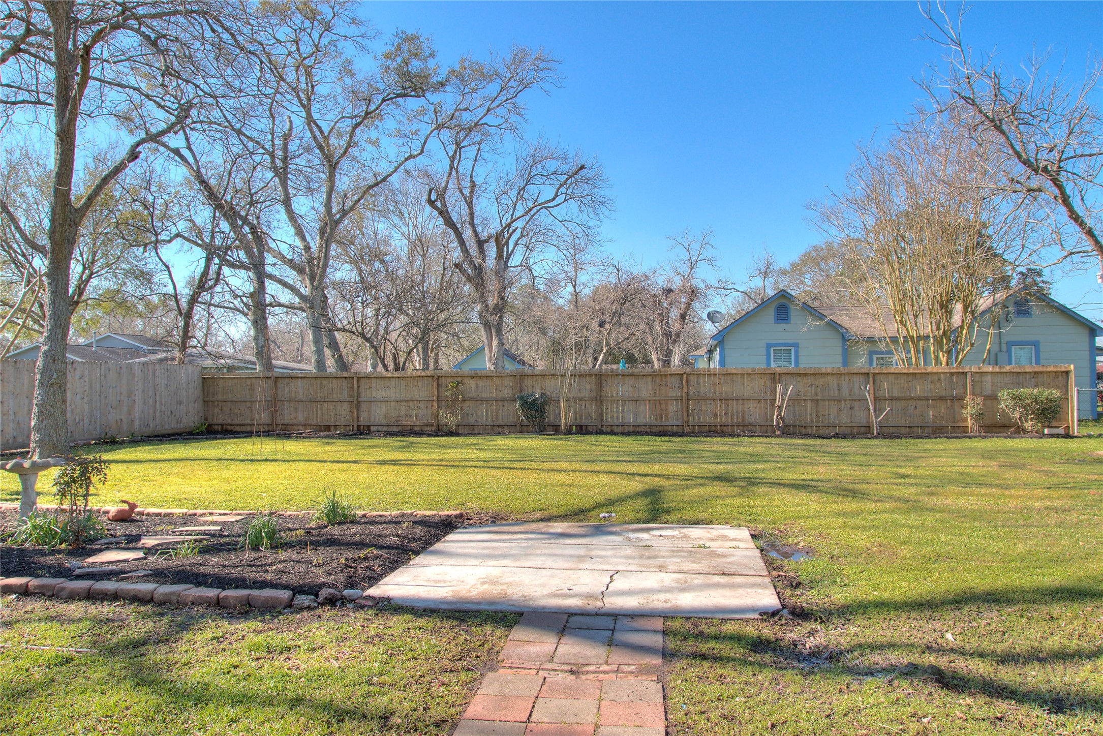 Expansive backyard perfect for gardening, a playground, or a pool.