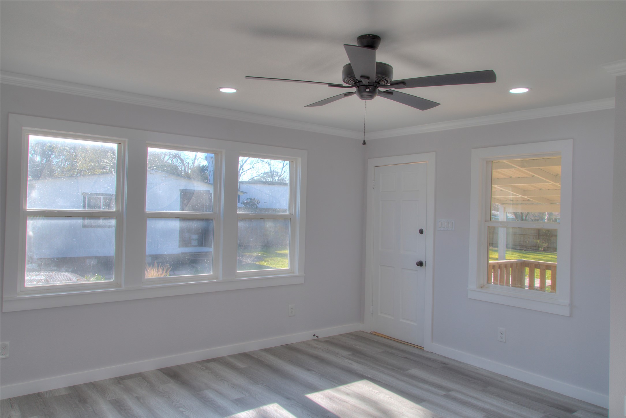 Bright dining/family room with a large window offering serene backyard views. Bright dining/family room with a large window offering serene backyard views.