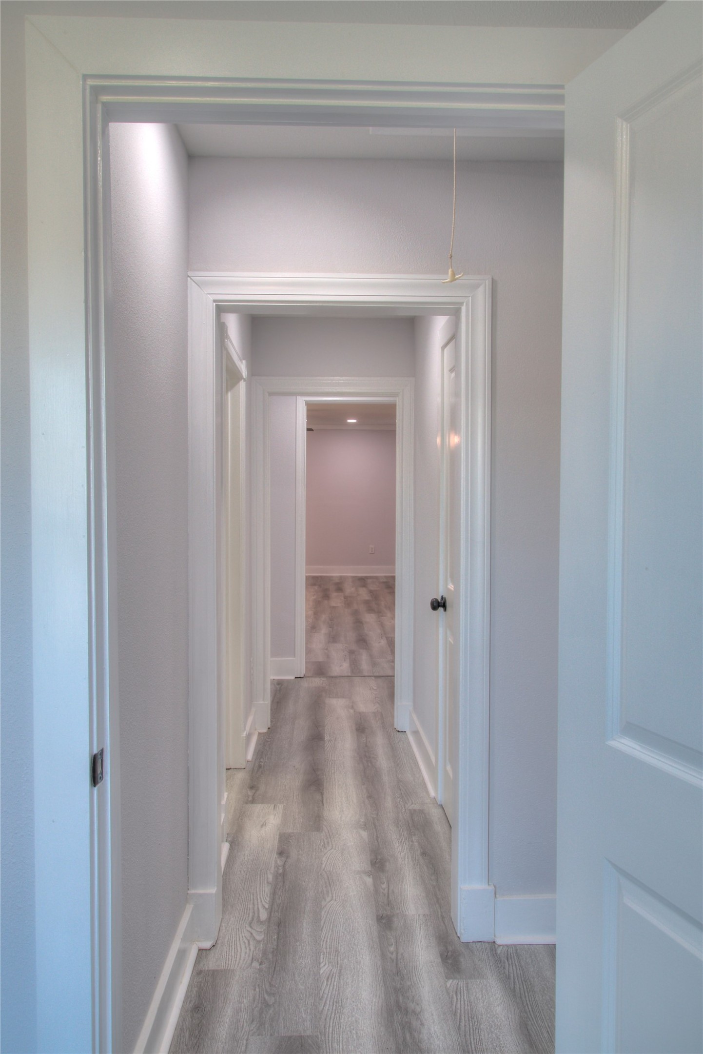 A welcoming hallway seamlessly connecting the primary suite with additional bedrooms.