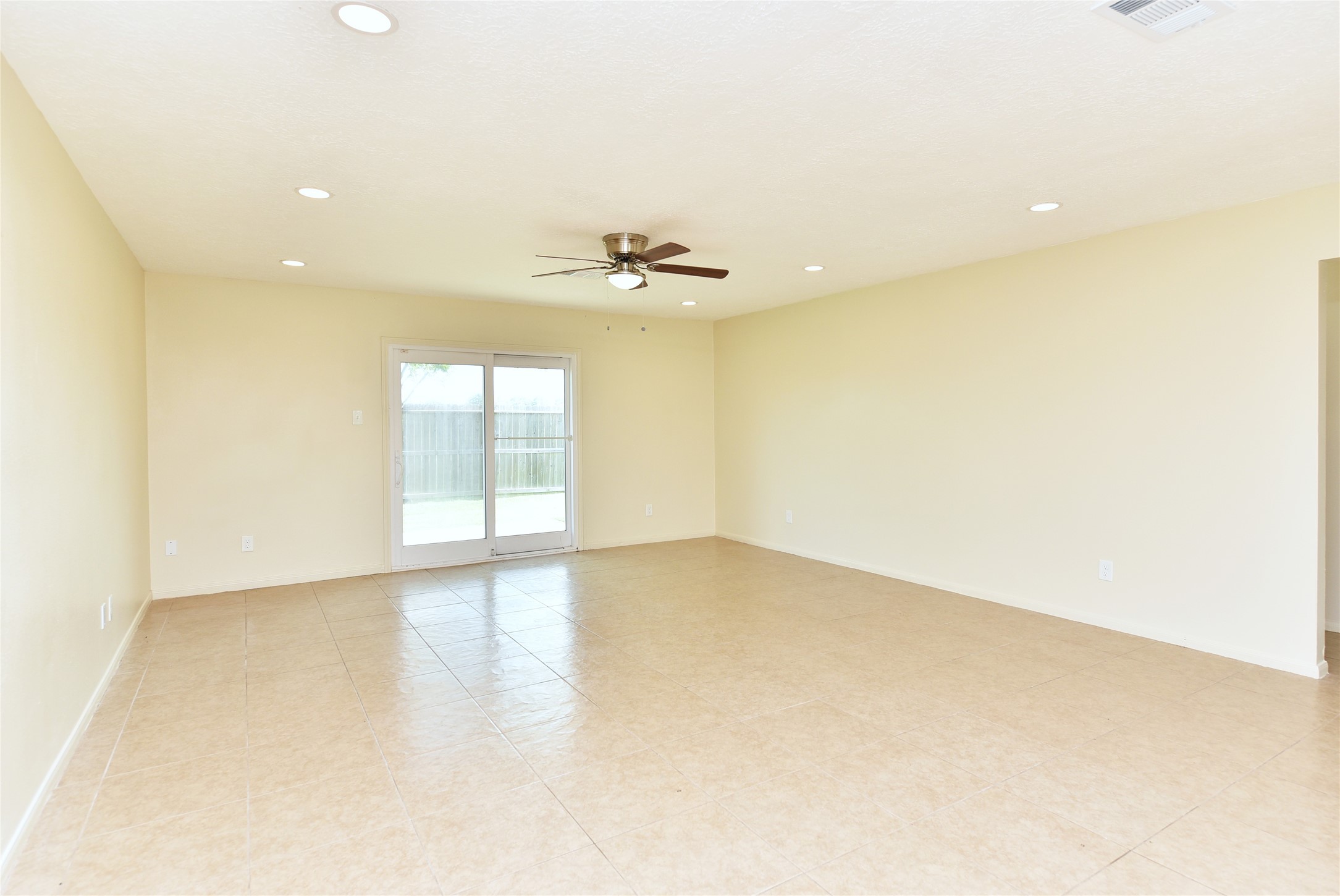 Tile flooring and a ceiling fan. Tile flooring and a ceiling fan.