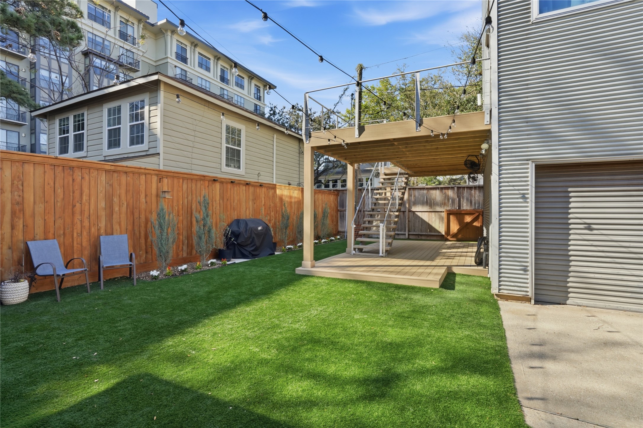 Low-maintenance backyard with durable turf, fenced privacy, and space for outdoor seating or play.