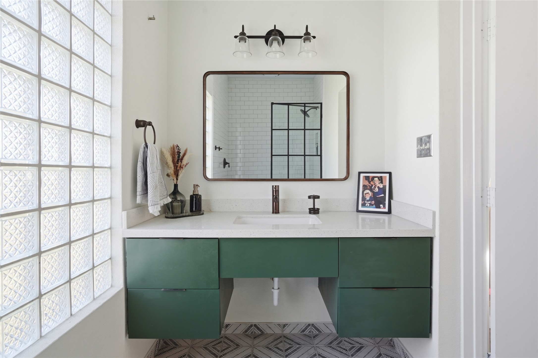 Full bathroom with large vanity and walk in shower.