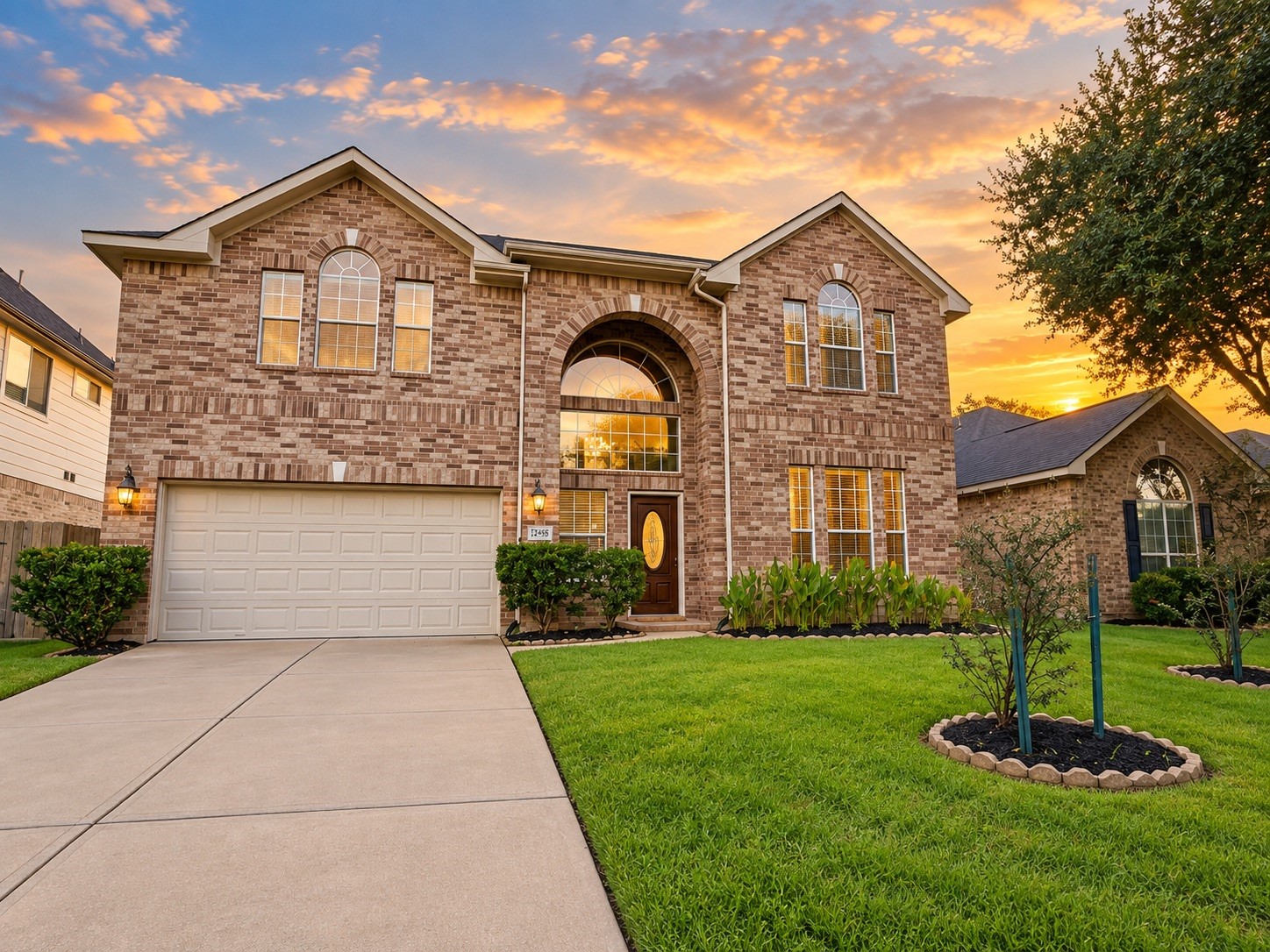 A stunning brick facade greets you in this spacious two-story home, accentuated by a beautifully manicured lawn and inviting entryway.