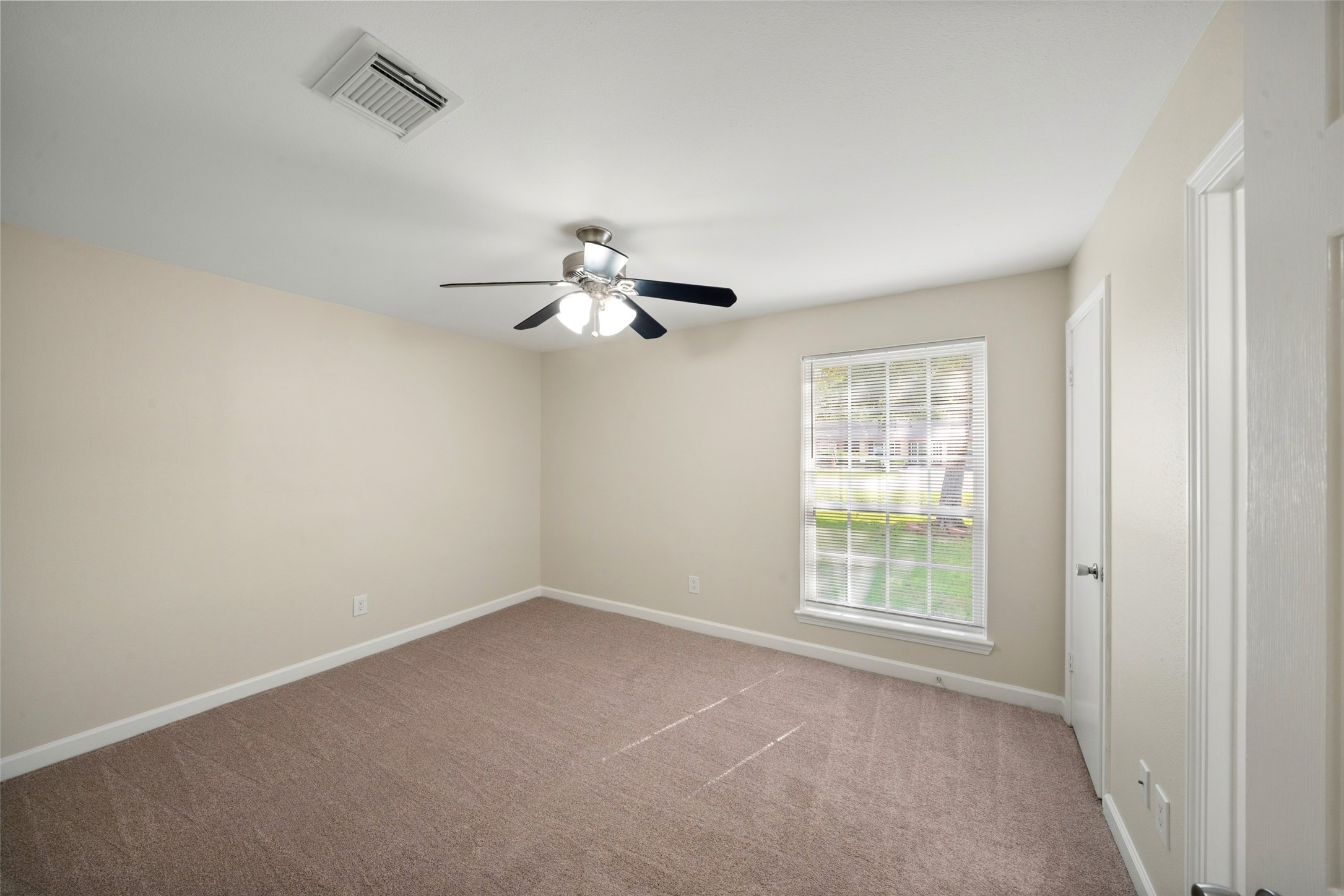 Secondary Bedroom; new carpeting, mini blinds and fresh paint on walls and baseboards.