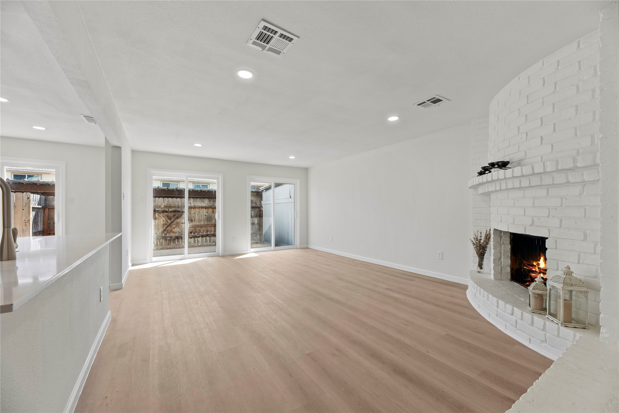 Back slidding doors and original brick fire place.