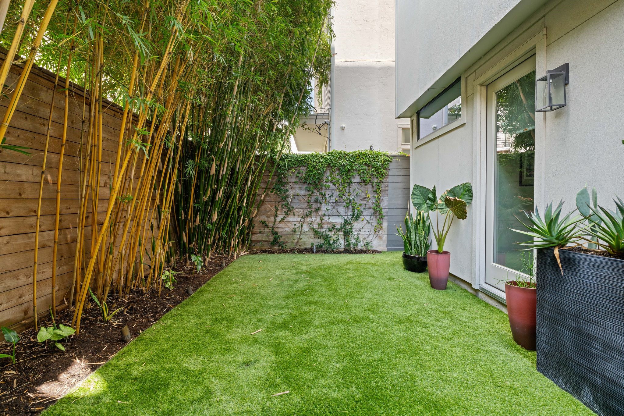 Rare, generously sized private backyard with artificial turf and professional landscaping, offering low-maintenance outdoor space in the heart of Upper Kirby.