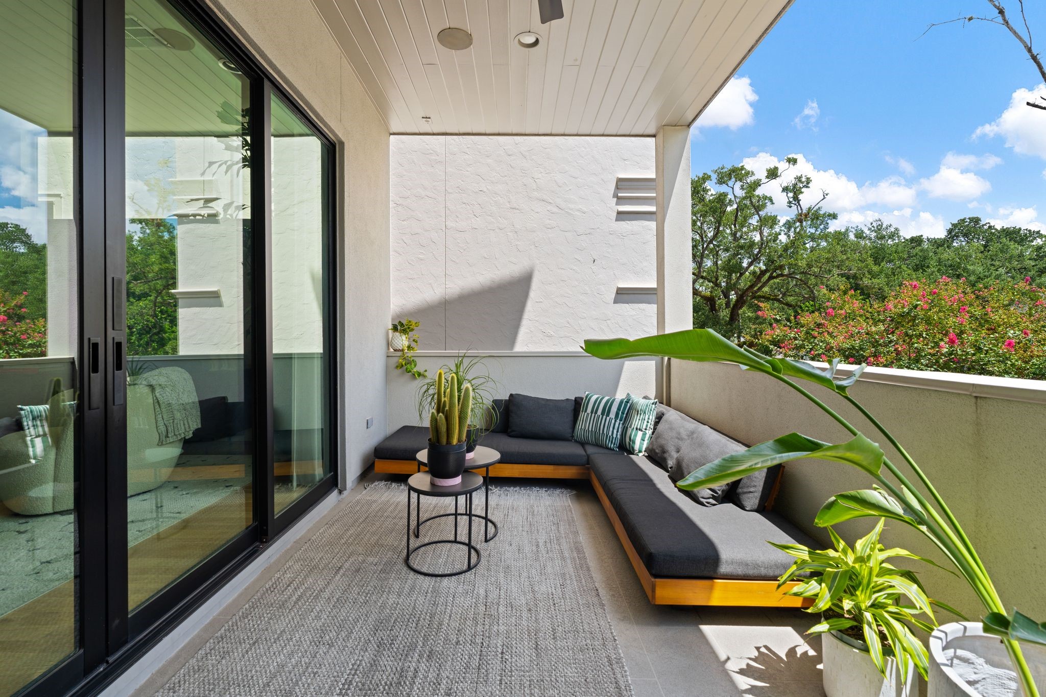 Covered second-floor terrace overlooking the mature treetops along Greenbriar, featuring an outdoor fireplace, built-in speakers and ceiling fan for comfortable outdoor living and entertaining. Covered second-floor terrace overlooking the mature treetops along Greenbriar, featuring an outdoor fireplace, built-in speakers and ceiling fan for comfortable outdoor living and entertaining.