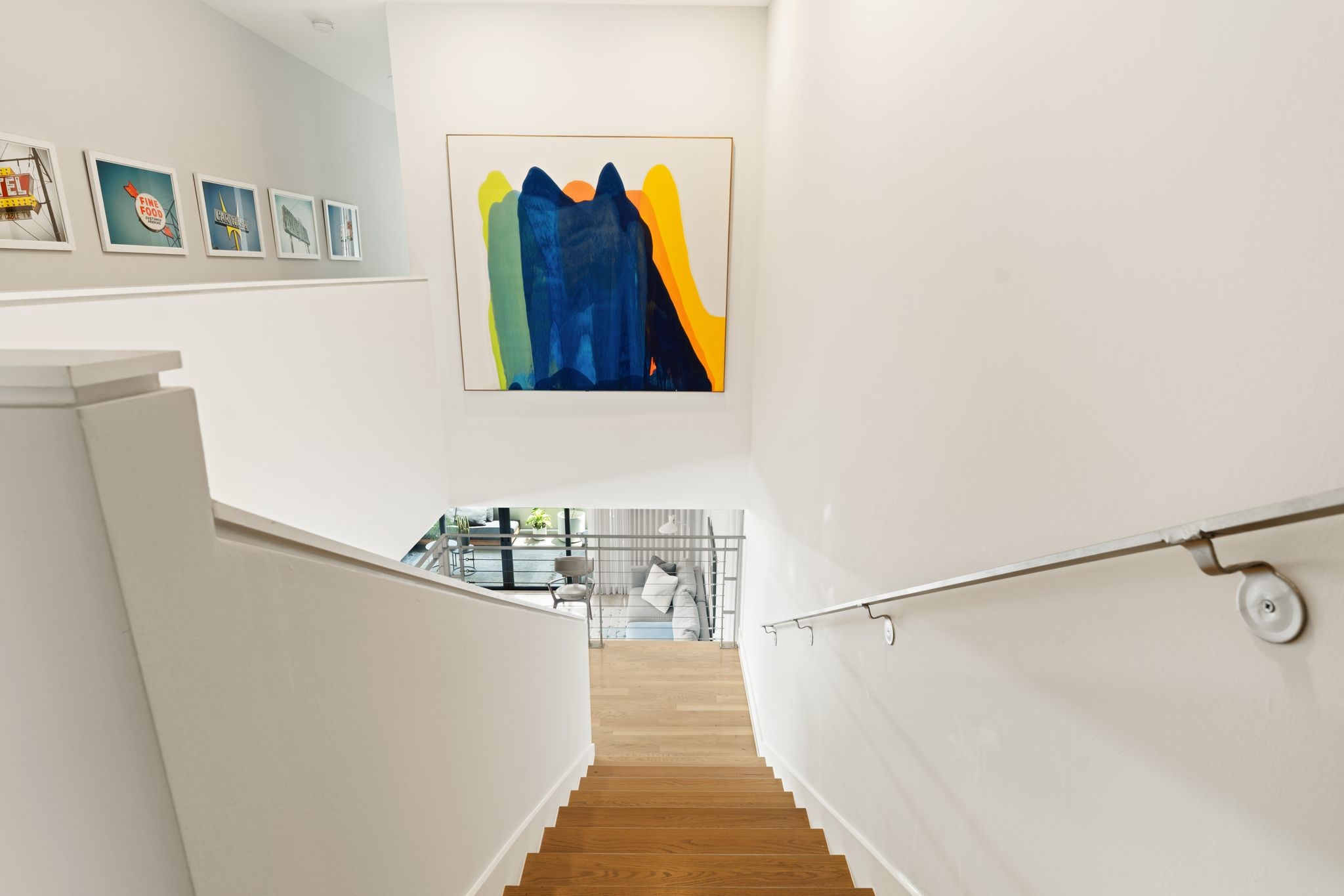 Thoughtfully designed stair and landing provide exceptional wall space for a gallery-style art display while connecting the homes second and third levels.