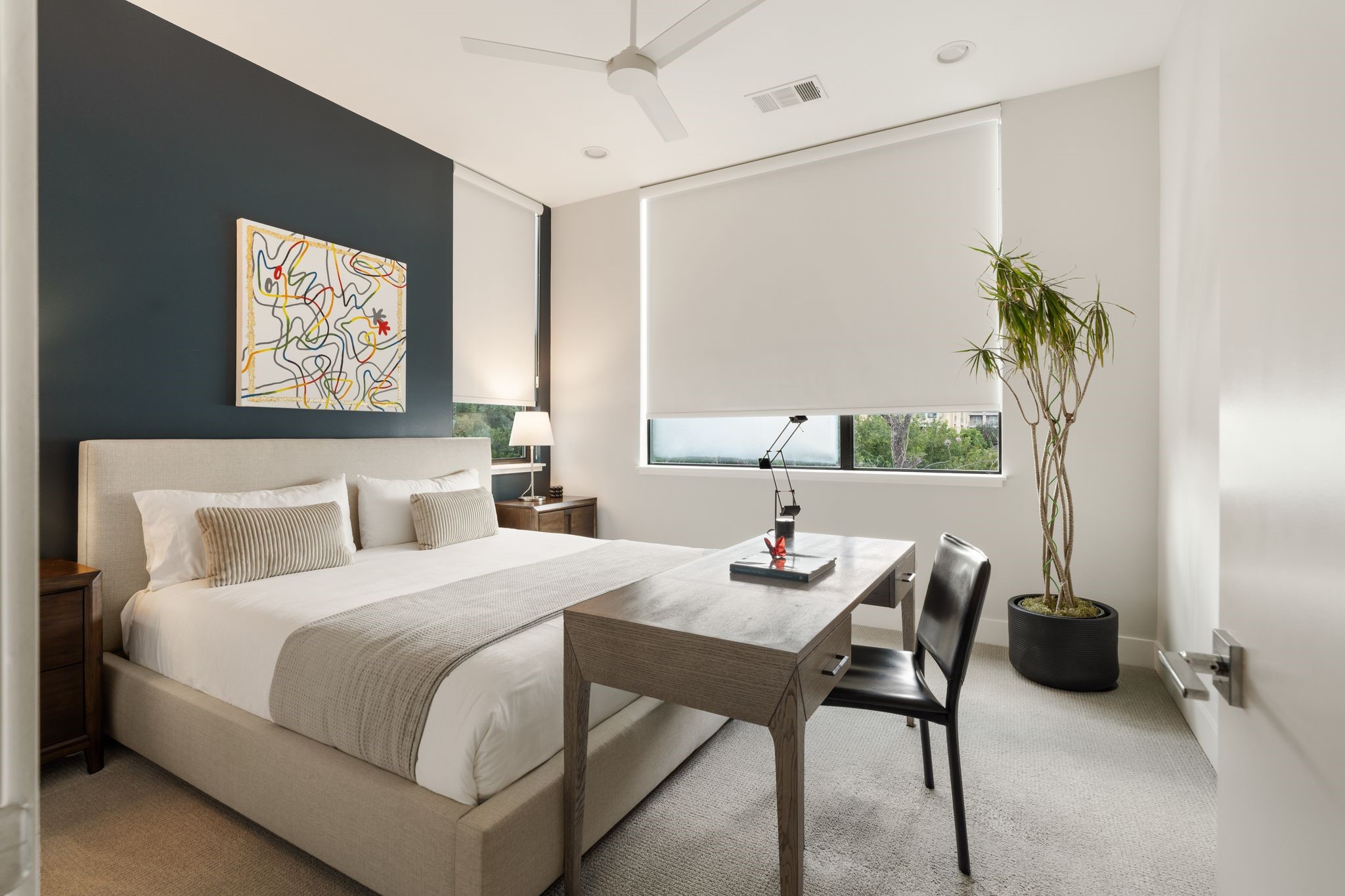 Versatile fourth bedroom with eastern exposure and beautiful morning light, currently arranged as a guest room and home office with its own private en suite bath.