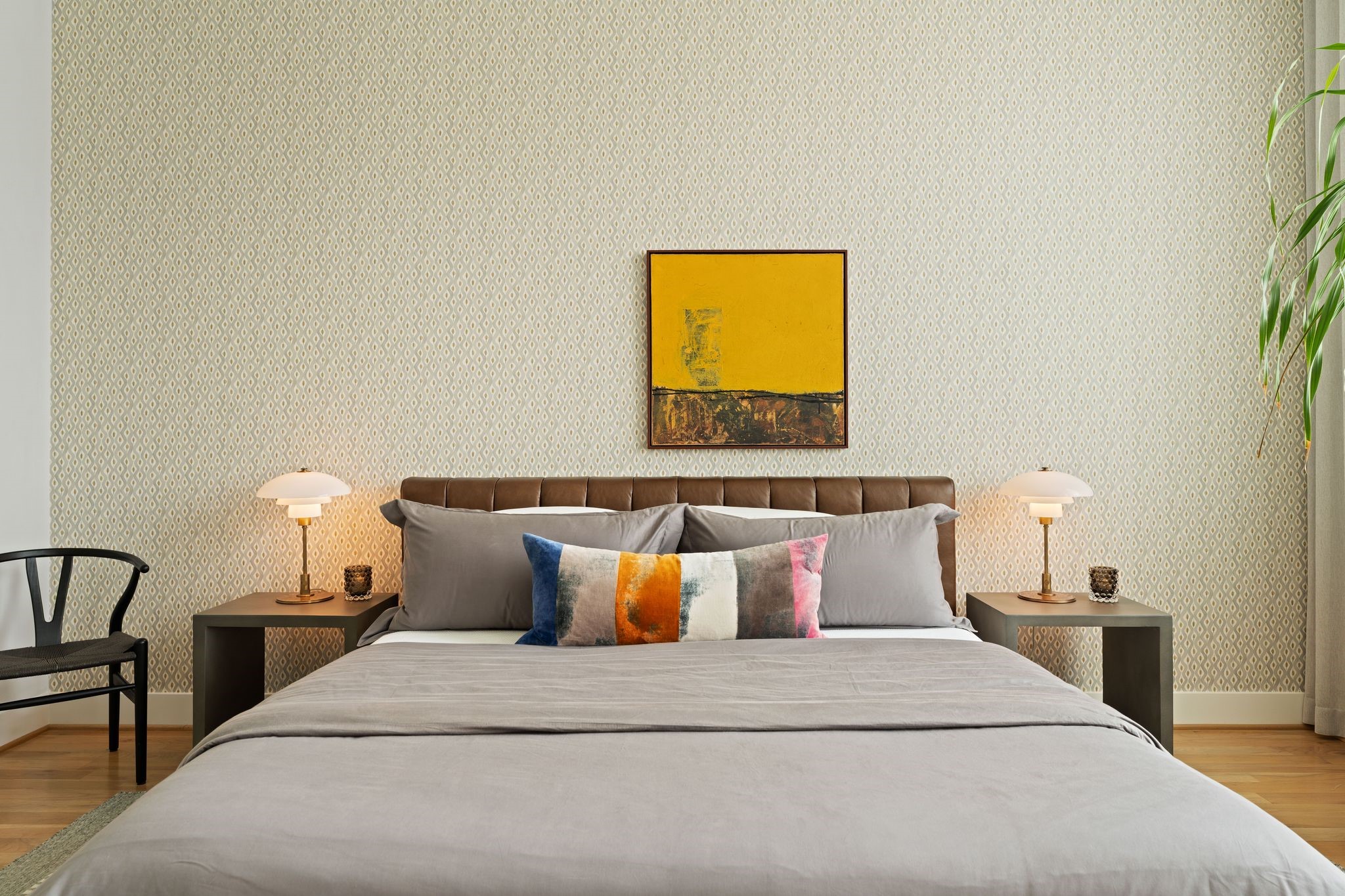 Spacious primary bedroom with high ceilings, hardwood floors, generous wall space, and west-facing windows providing beautiful afternoon light.