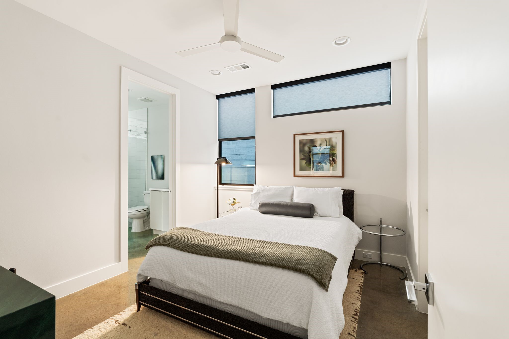 Comfortable first-floor guest bedroom with high ceilings, generous closet space, and convenient access to the adjacent full bath.