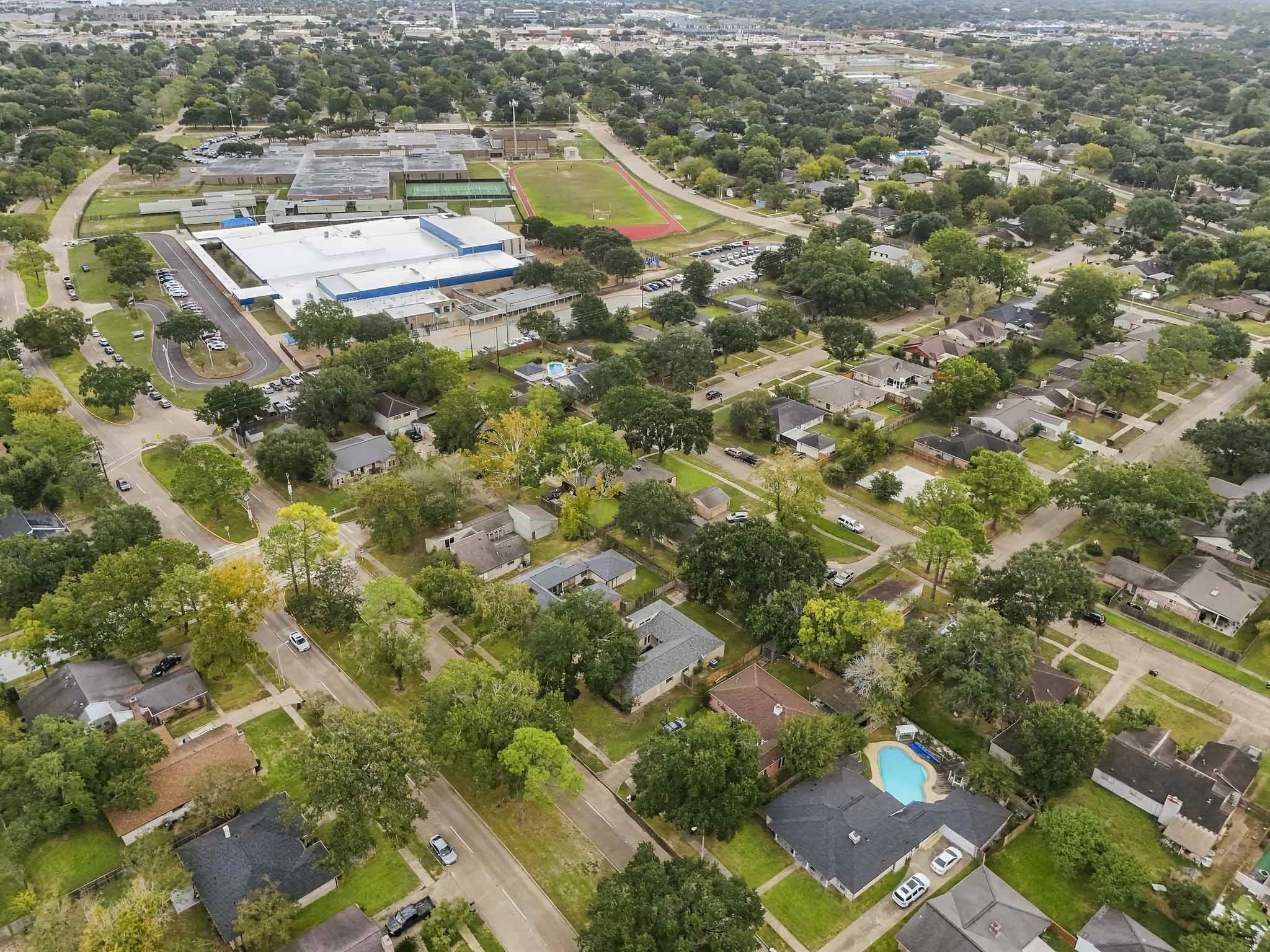 Overlooking the vibrant surrounding enclave, this high-angle vista emphasizes the remarkable appeal and community-centric location of the residence. Combining a tranquil neighborhood atmosphere with unbeatable convenience to schools and open-air activities, this property enjoys an enviable setting.