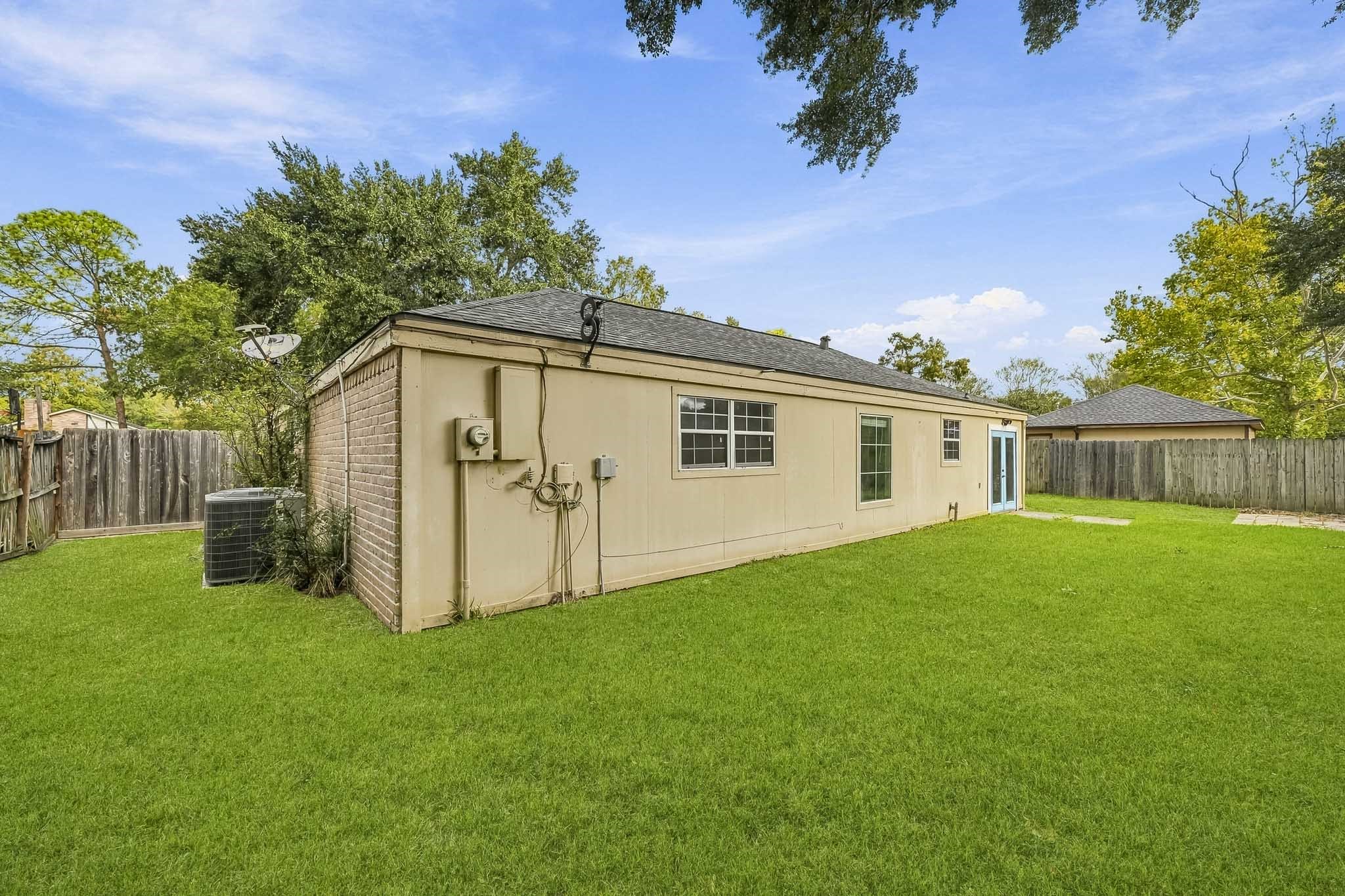 With its sturdy construction, single-level design, and substantial side and rear acreage, the property creates a warm and versatile open-air retreat.