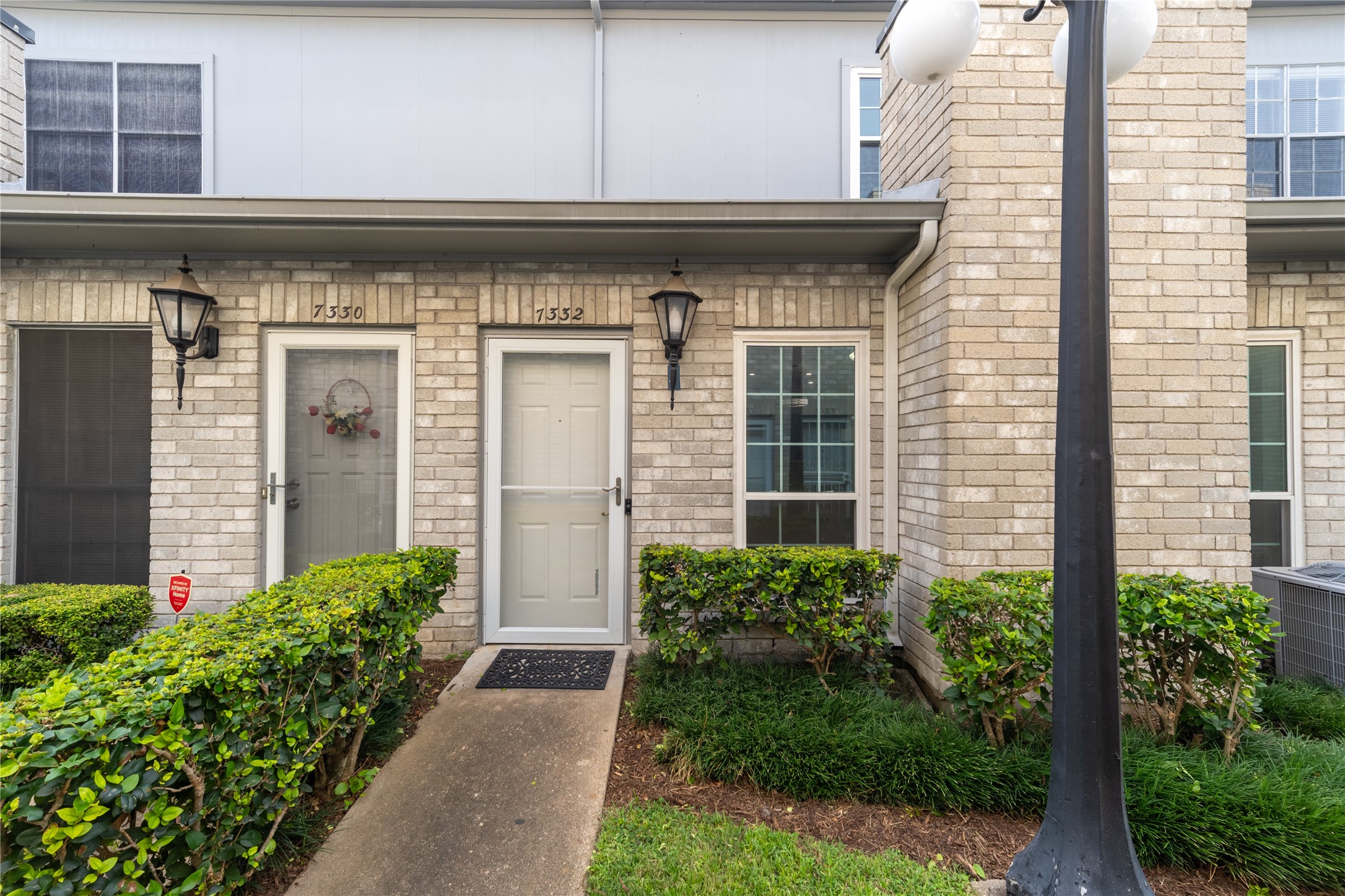 Charming brick exterior with a private landscaped entrance