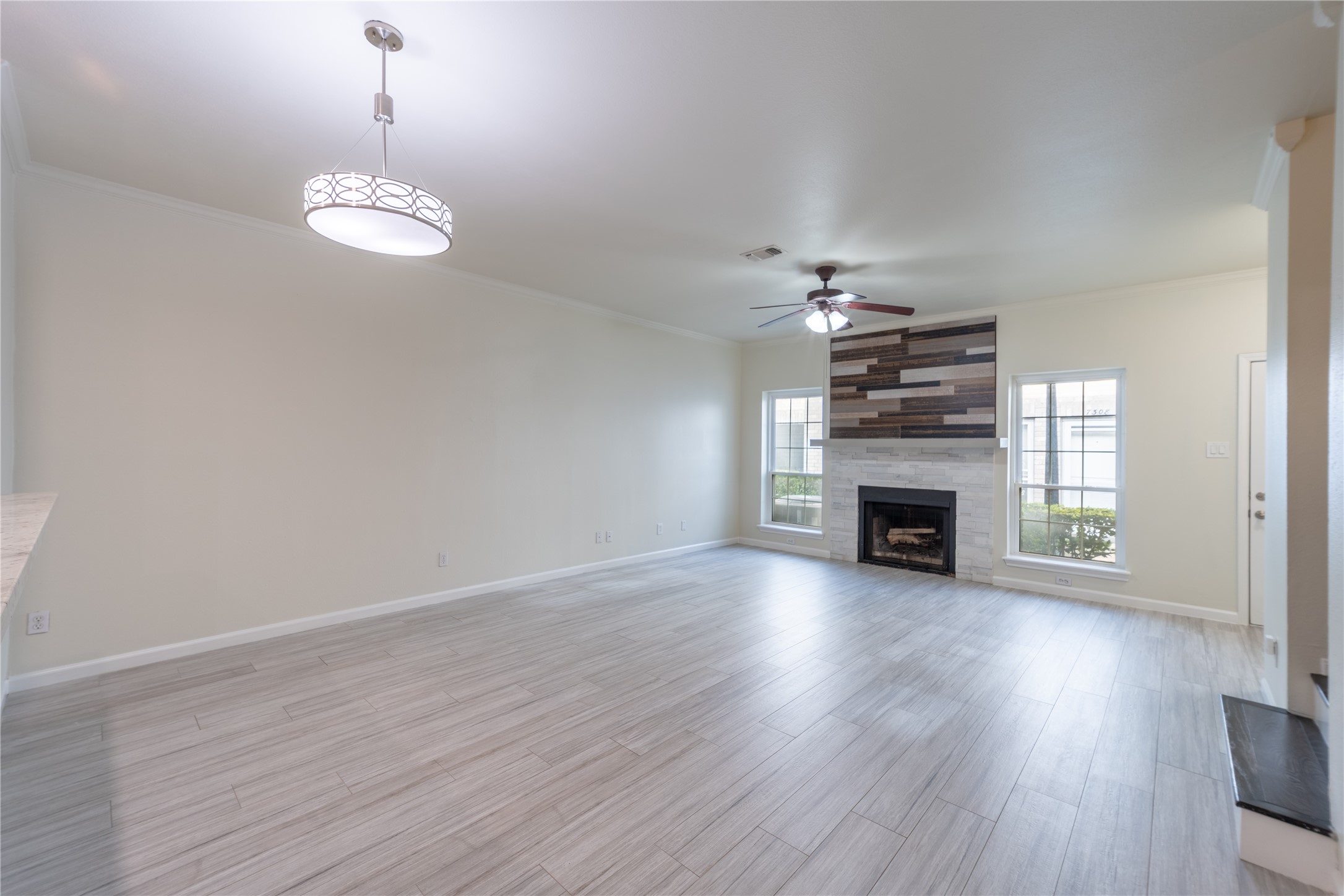 Spacious living and dining area with a modern fireplace and abundant natural light.