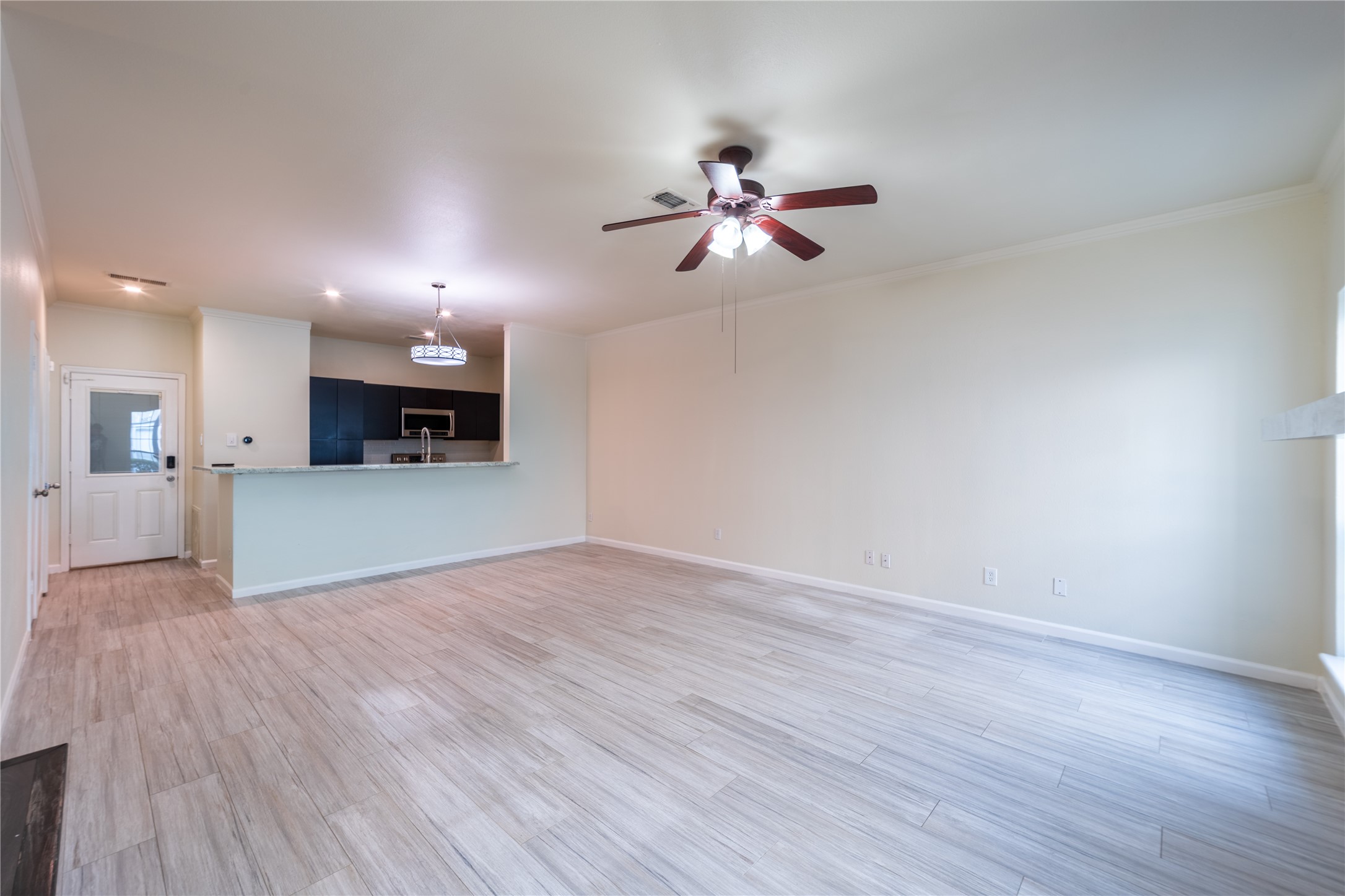 Bright, open-concept living and dining area with modern flooring