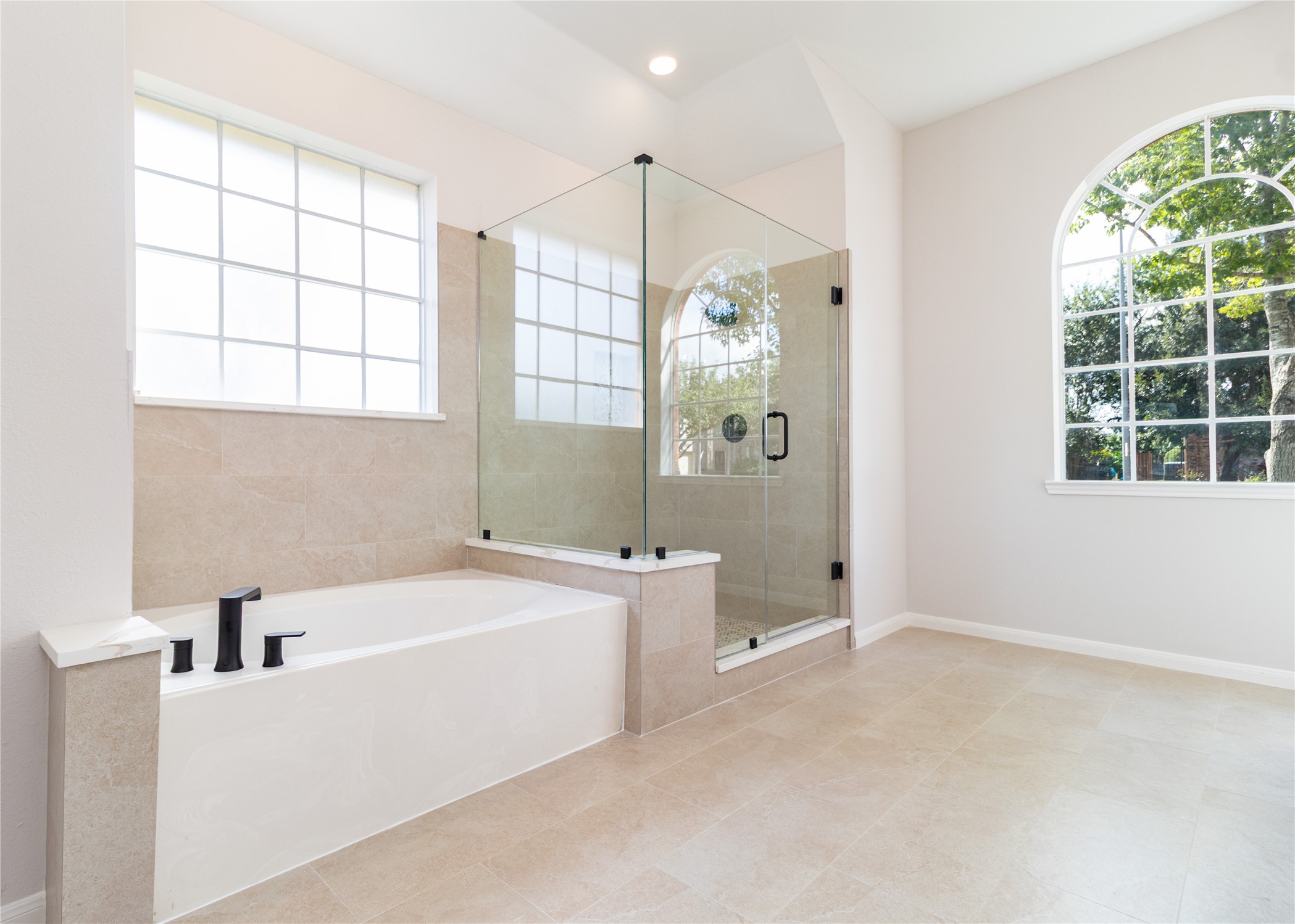 The primary bath was completely updated with new shower glass, tile, fixtures, cabinets, quartz tops, mirrors, and more.