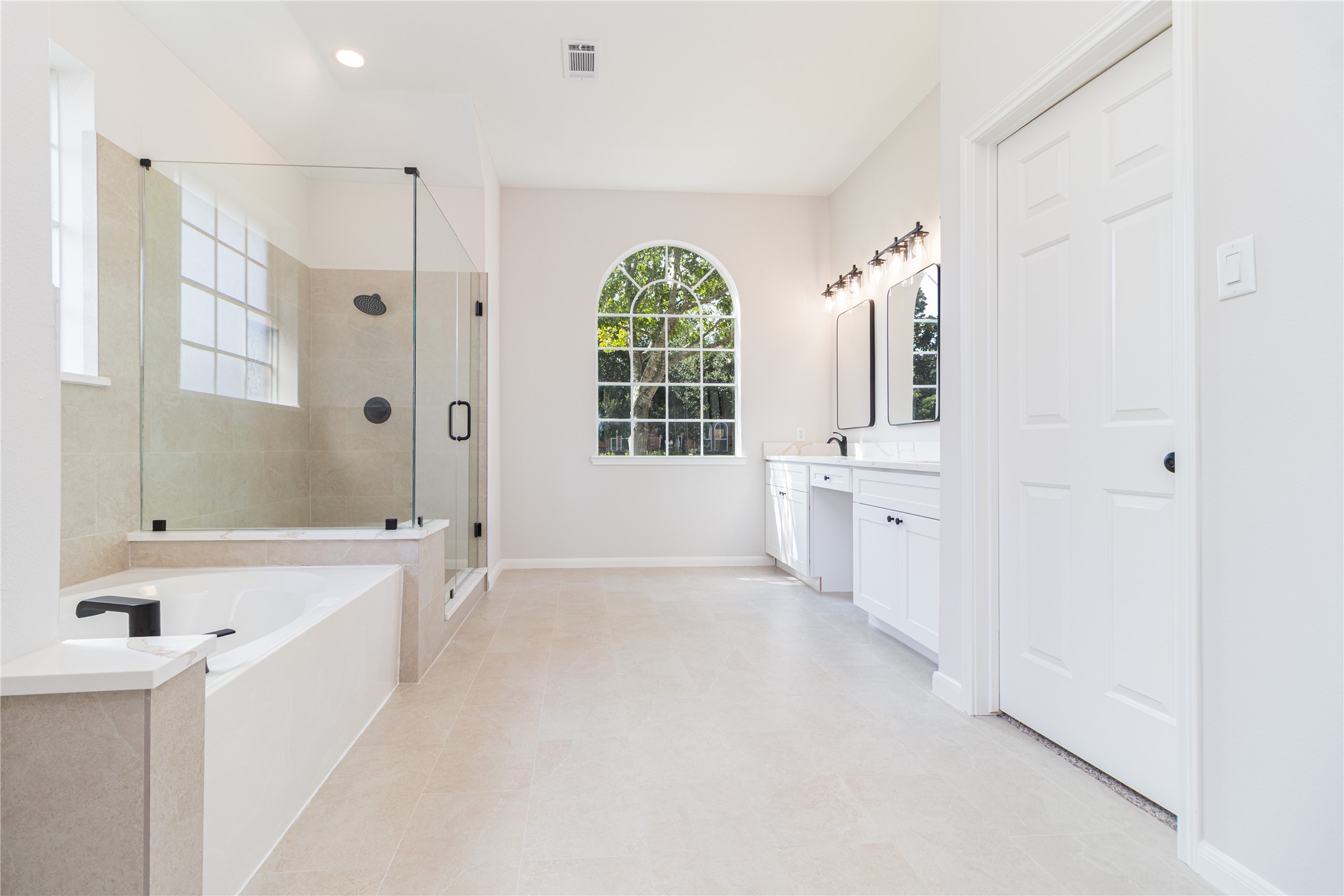 The primary bath was completely updated with new shower glass, tile, fixtures, cabinets, quartz tops, mirrors, and more.