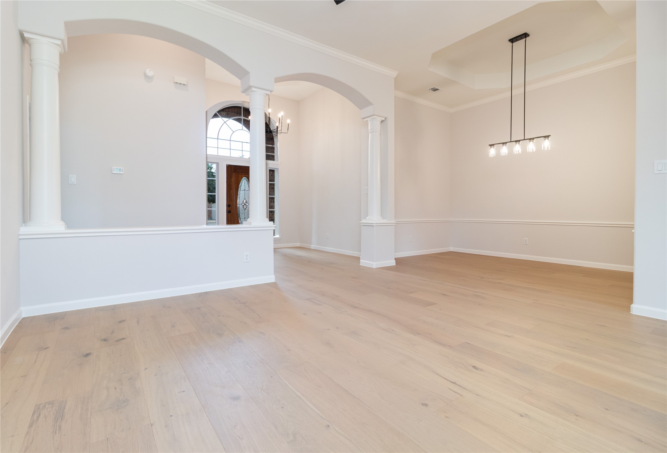 This view is from the formal living room or study, looking at the dining room, foyer, and small hallway to the primary bedroom. Also offers high ceilings. This view is from the formal living room or study, looking at the dining room, foyer, and small hallway to the primary bedroom. Also offers high ceilings.